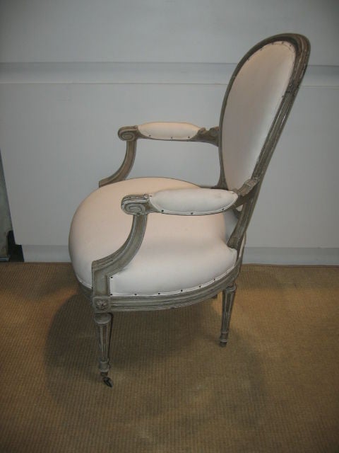 Oval back armchair with traditional neoclassical styling. Newly upholstered and tightened. Nailhead trim. Beautifully painted in Gustavian grey tones with an antiqued paint wash.