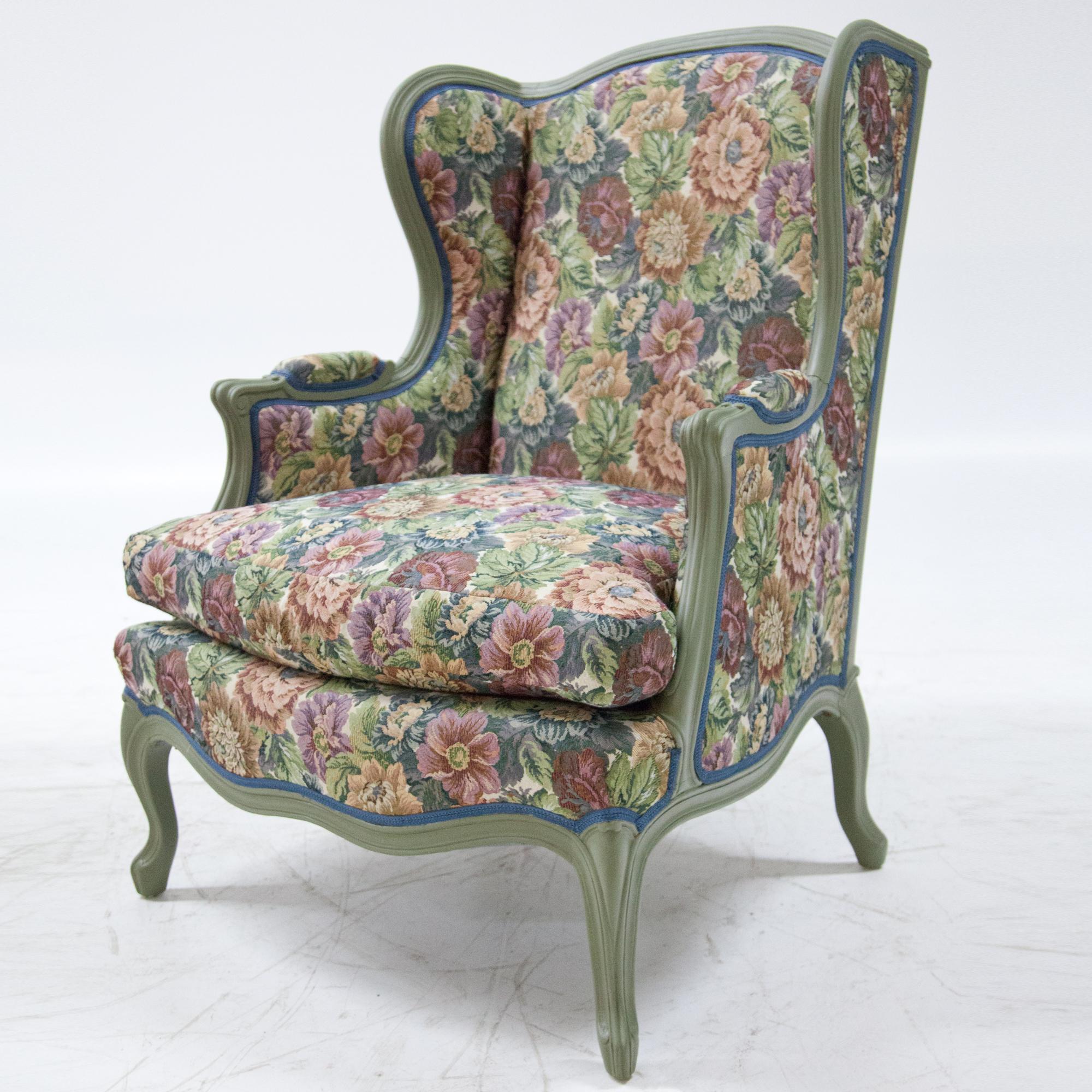 Four winged armchairs on s-legs with a double curved front rail and high backrests. The chairs were recently covered with a floral fabric and painted in mint green.