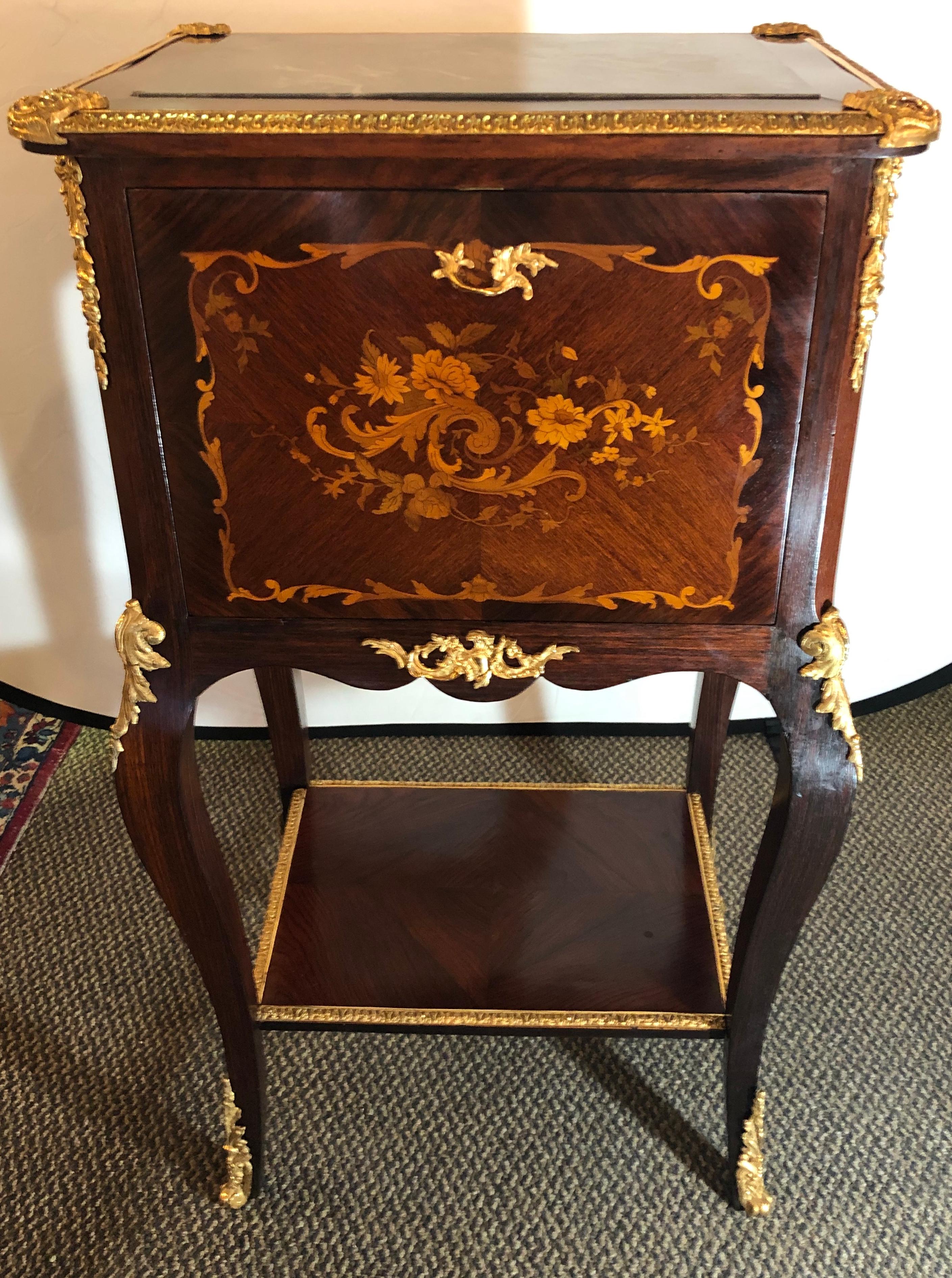 Very fine Louis XV style bar cabinet with gilt bronze mounts and floral marquetry. Unusual large size.
Hardware stamped with double keys signed Brevete Paris. Measurements when fully open are 38 inches depth x 42.5 inches width. Fully refinished to