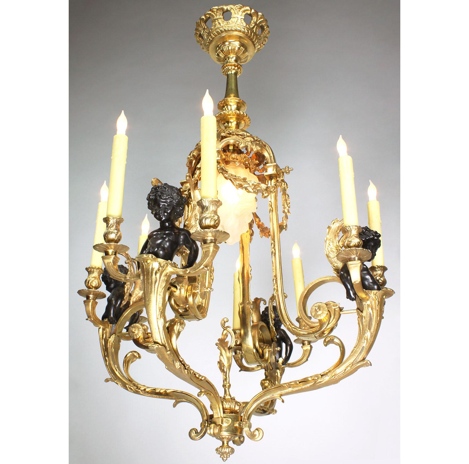 A French Louis XV Style Belle Époque gilt and patinated bronze nine-light cherub chandelier. The open gilt bronze body frame surmounted with four pairs of candle arms, now electrified, each emanating from a patinated bronze cherub, the copula shaped