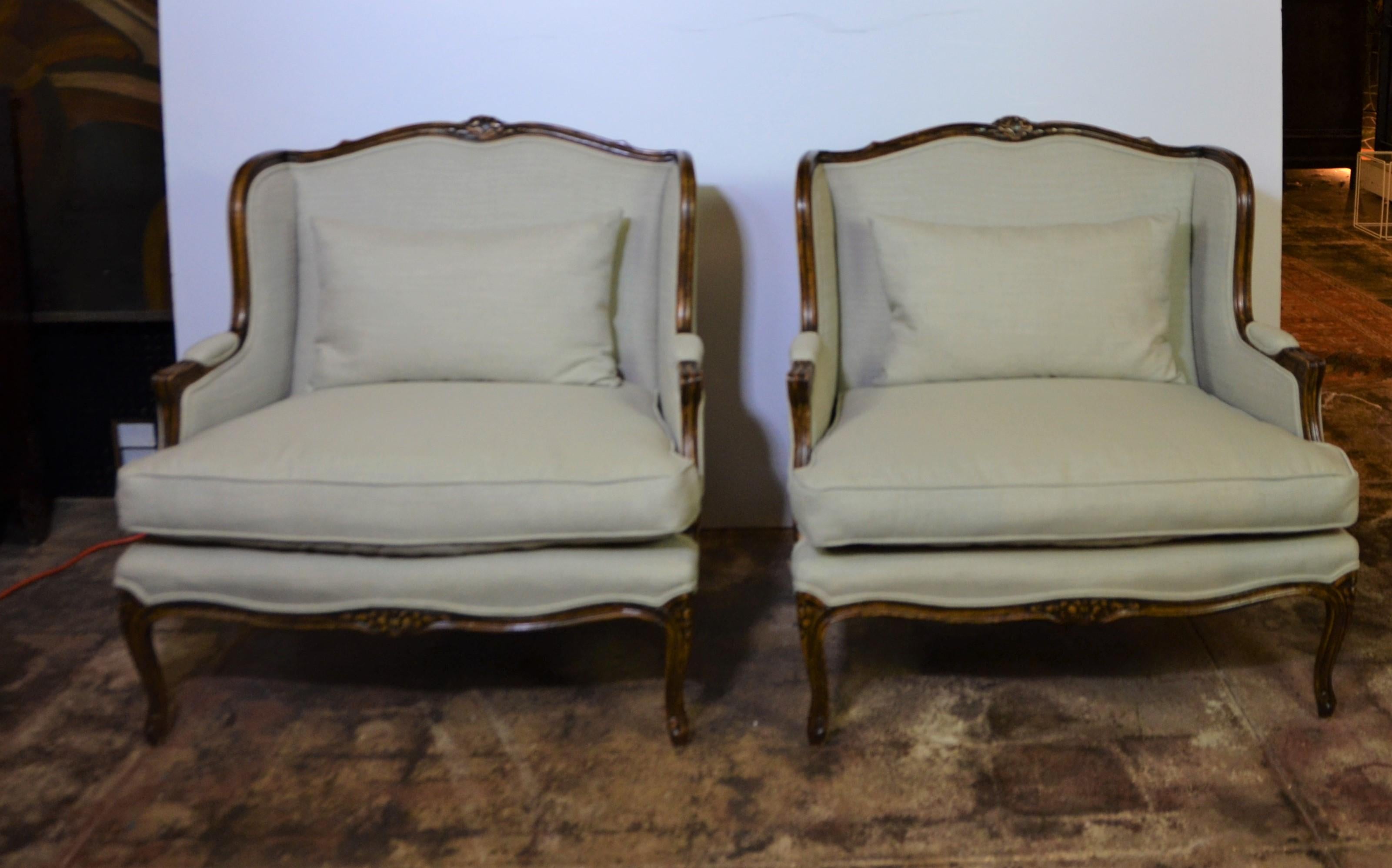 Pair of Louis XV style Classic style Bergere chairs. The chairs are newly upholstered in light gray color fabric.