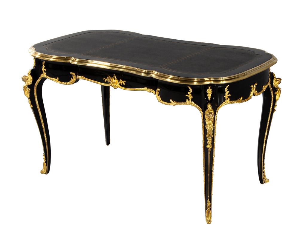 Exquisite antique Louis XV style writing desk, crafted in France in the early 1900's. This stunning piece of furniture features all original brass ornaments, reflecting the intricate and elegant design of the Louis XV era. Meticulously restored to