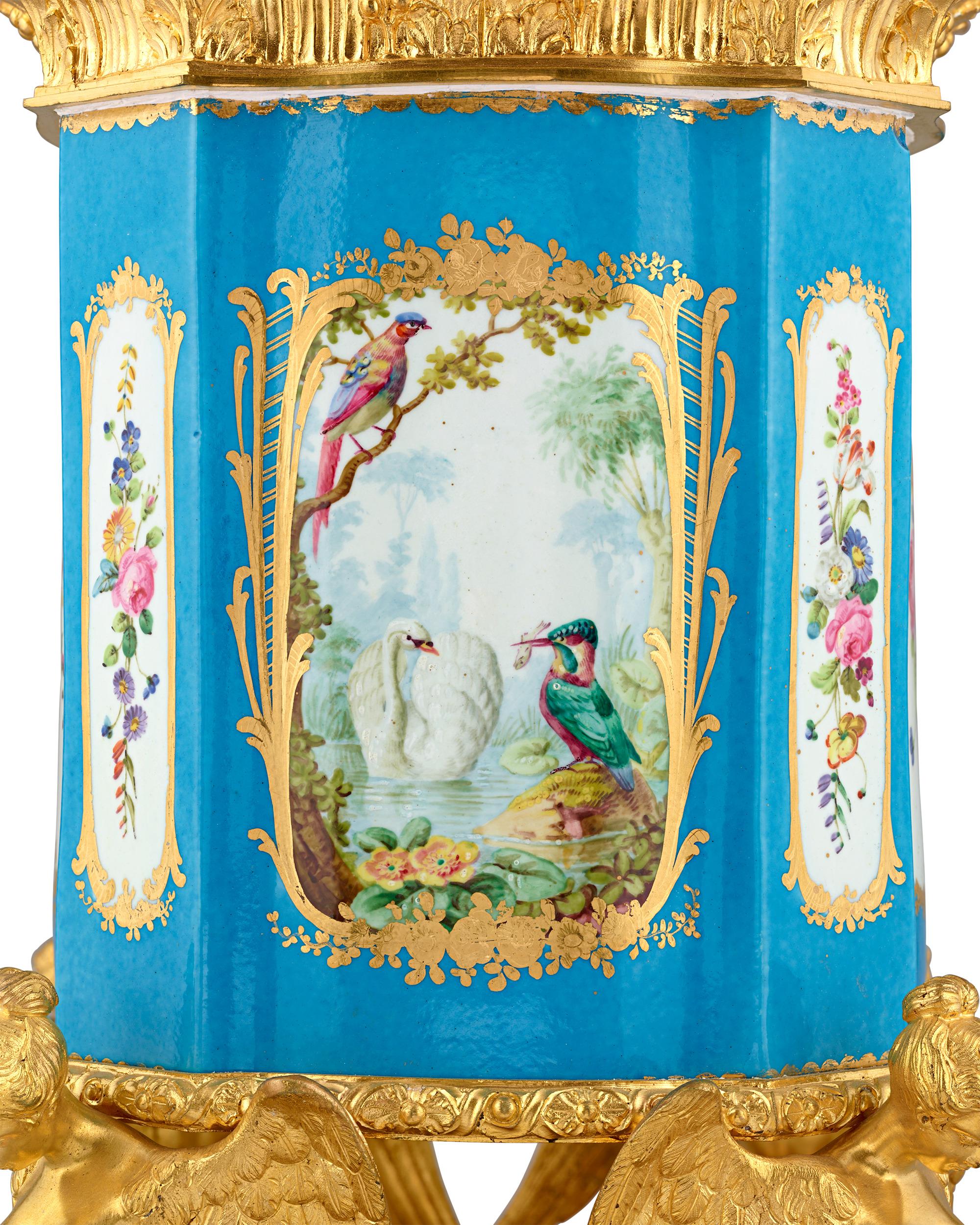 Drawing from the luxury of Sèvres Porcelain and Louis XV's famed bleu céleste service from Versailles, this elegant French porcelain vase features the trademark shade of blue and medallions revealing scenes of flora and fauna, including pheasants
