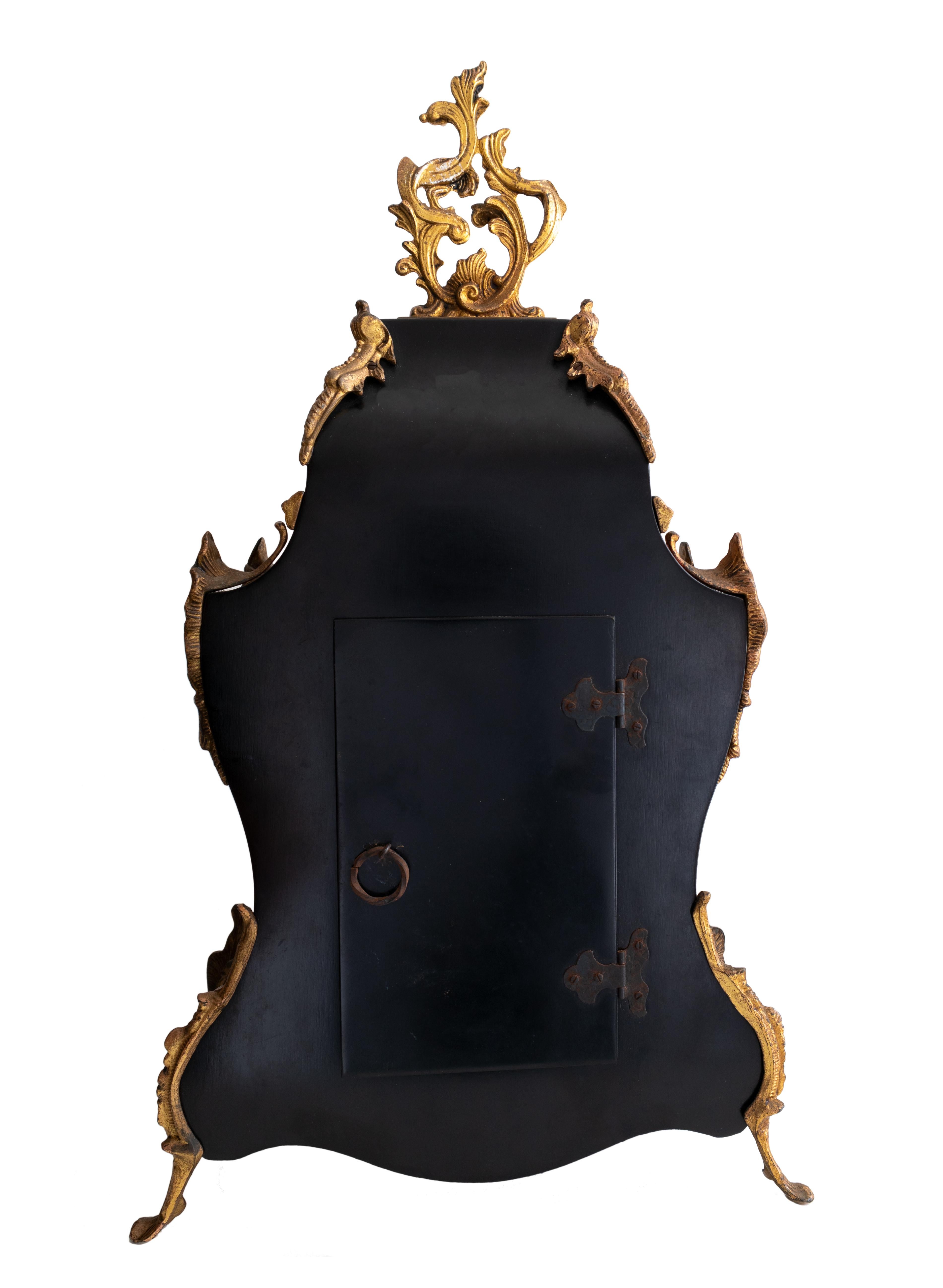 An elegant Louis XV style Boulle mantel clock with tortoiseshell pattern finish and intricate gilt bronze mounts, featuring a radiant sun pendulum and original key. 

The case showcases the classic Boulle aesthetic, with a deep red-brown- yellow