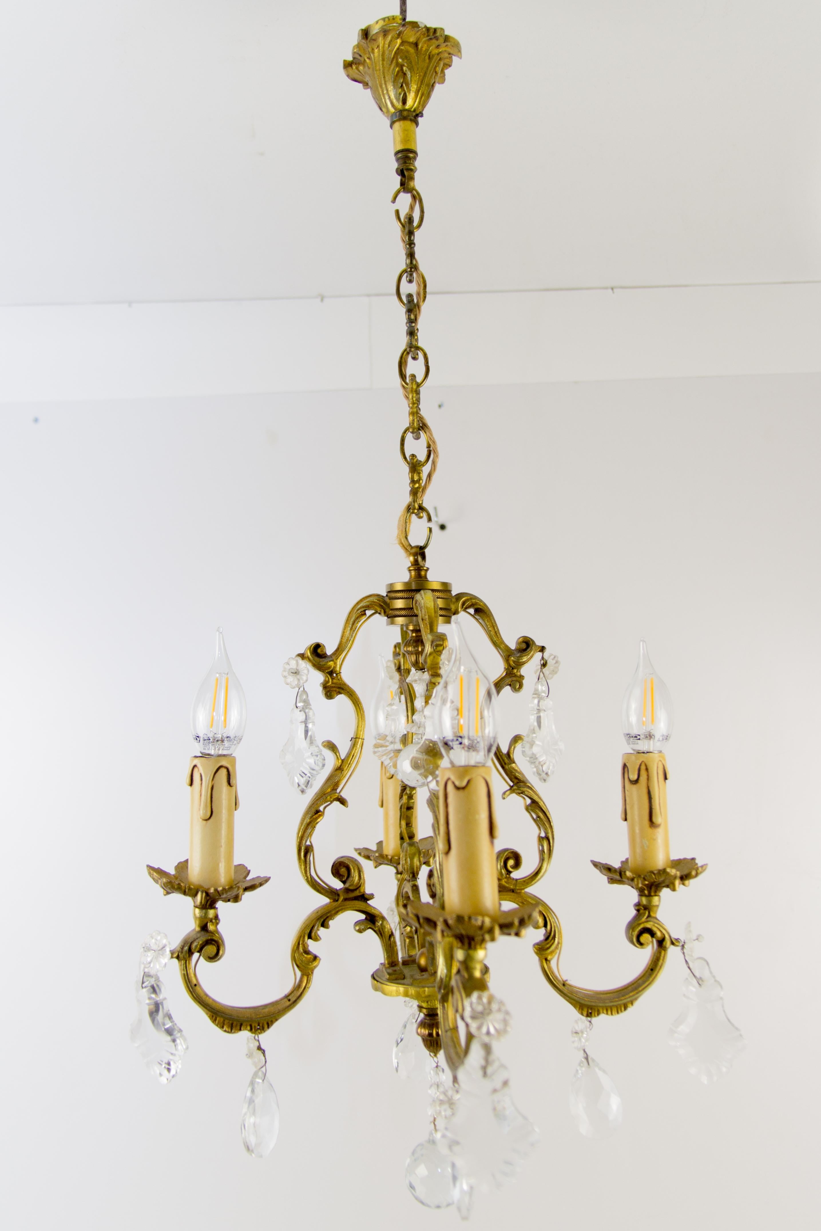 Very nice Louis XV or Rococo style vintage bronze and crystal four-light chandelier.
Four bronze arms, each with a socket for an E14-size light bulb.
Measures: height is 29.33 inches / 74.5 cm with chain, 21.65 in / 55 cm without chain; diameter –