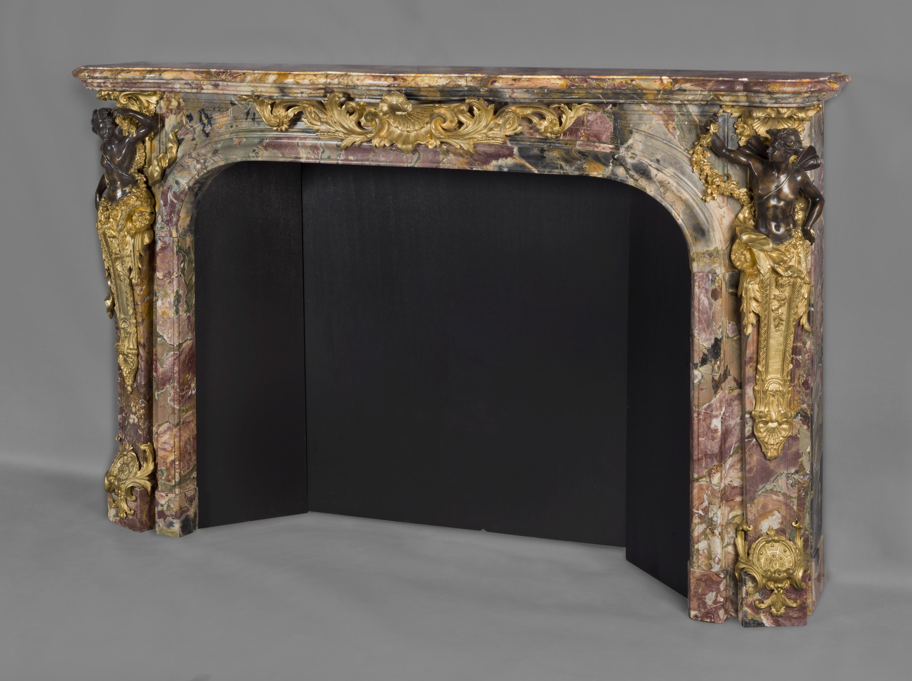 A fine louis XV style gilt and patinated bronze-mounted marble fireplace with mounts depicting Flora and Zephyr, after the model by Verberckt and Caffieri at Versailles. 

French, circa 1860. 

This rare and impressive fireplace has a serpentine