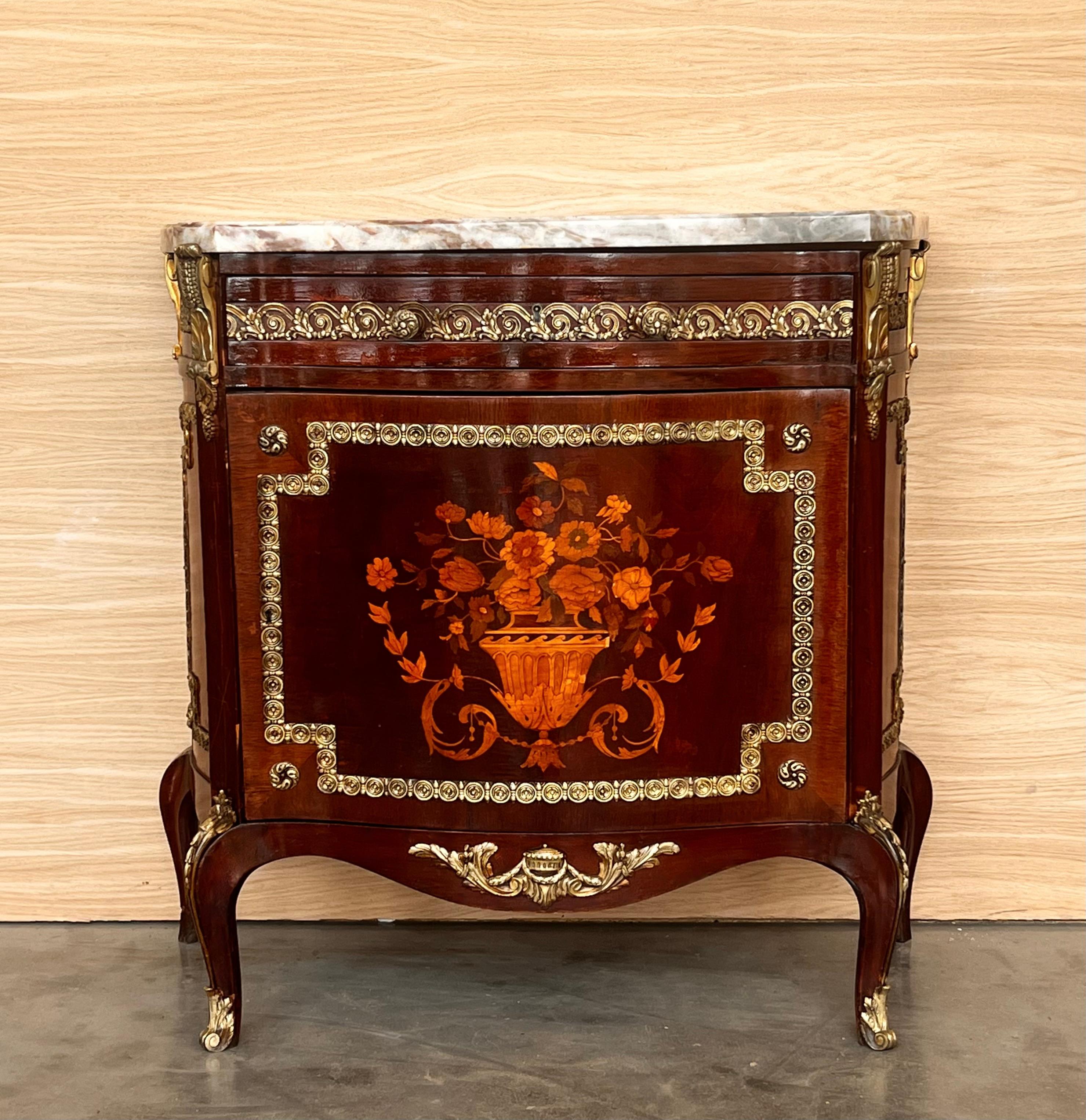 This stunning and extremely rare 19th century Louis XV-style buffet opens at the front with a single door and drawer. Adorned with intricate floral marquetry, the door displays a bouquet in a vase set within a frame highlighted by a border in