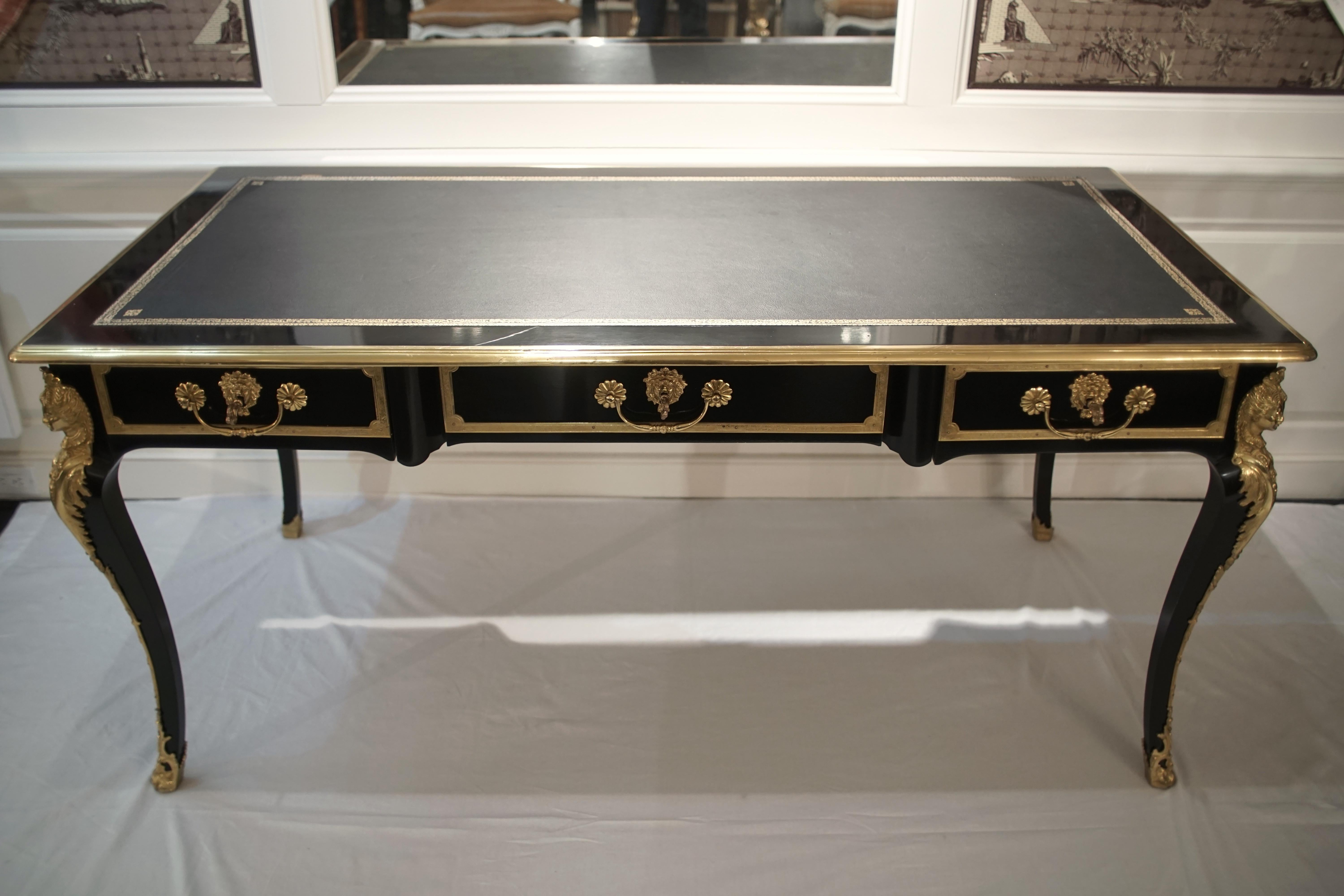 Louis XV style bureau plat desk, black with gilded bronze details. Tooled leather top. Ebonized.

Dimensions: 63” W x 29.5” H x 31.5” D
Leg space: 23.5