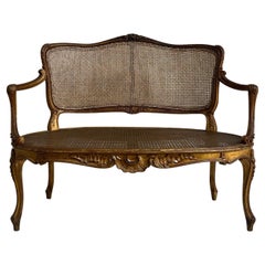 Louis XV Style Canape in Carved and Gilded Wood. Cane Backrests and Seats