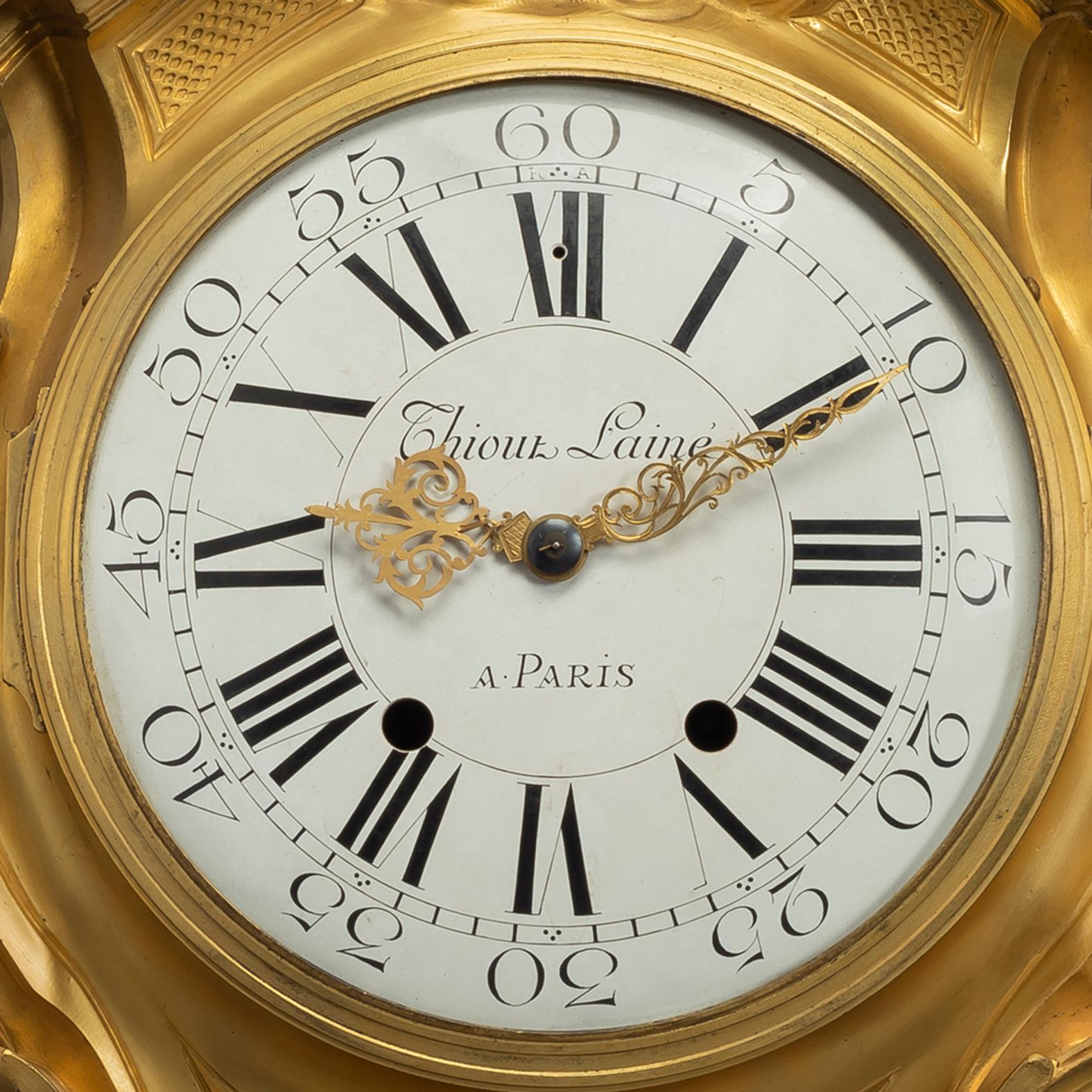 A fine Louis XV style gilt-bronze cartel d'Applique, after a model by Jacques Caffieri.

The white enamel dial inscribed 'Thiout Lainé/A PARIS', with hours in Roman numerals and seconds in Arabic numerals, with pierced gilt-bronze scrolling hands.