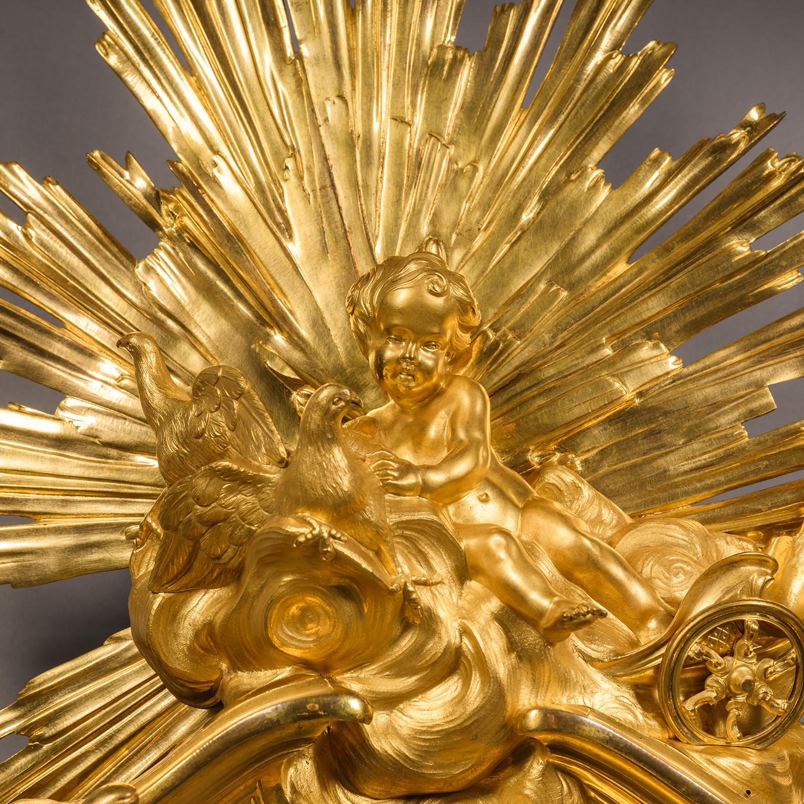 A fine Louis XV style gilt-bronze cartel d'Applique, after a model by Jacques Caffieri.

The white enamel dial inscribed 'Thiout Lainé/A PARIS', with hours in Roman numerals and seconds in Arabic numerals, with pierced gilt-bronze scrolling hands.