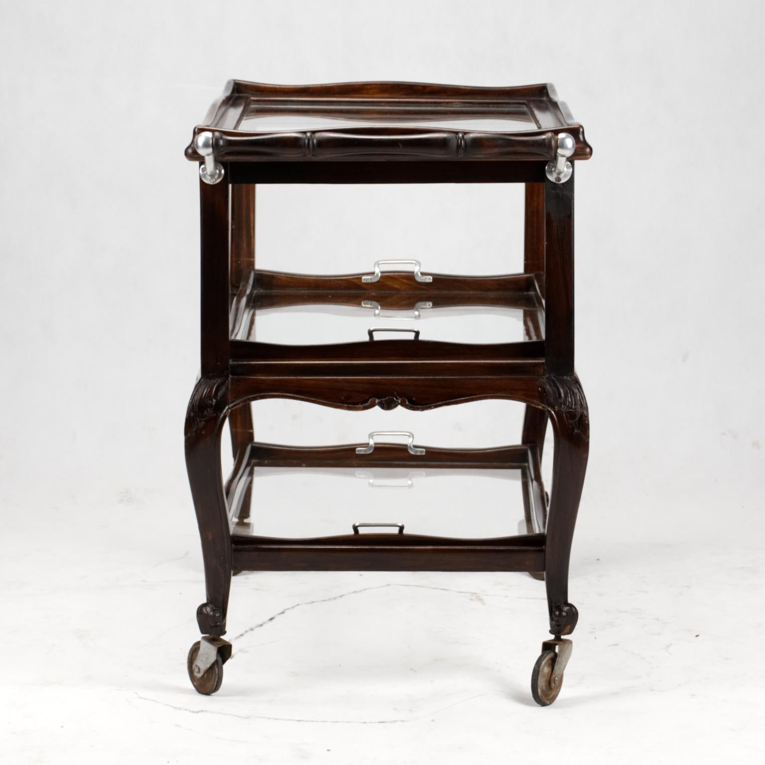 Carved Louis XV style bar cart with removable glass shelves.