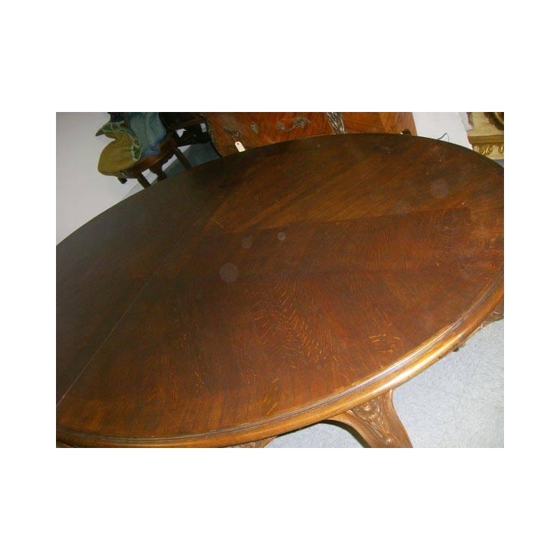 Unique 19th century Louis XV style finely carved oval oak dining table. The parquetry top on unusually curved frieze carved with shell and acanthus motif on eight cabriole legs ending in scrolled feet. 
Table includes two leaves.

This particular