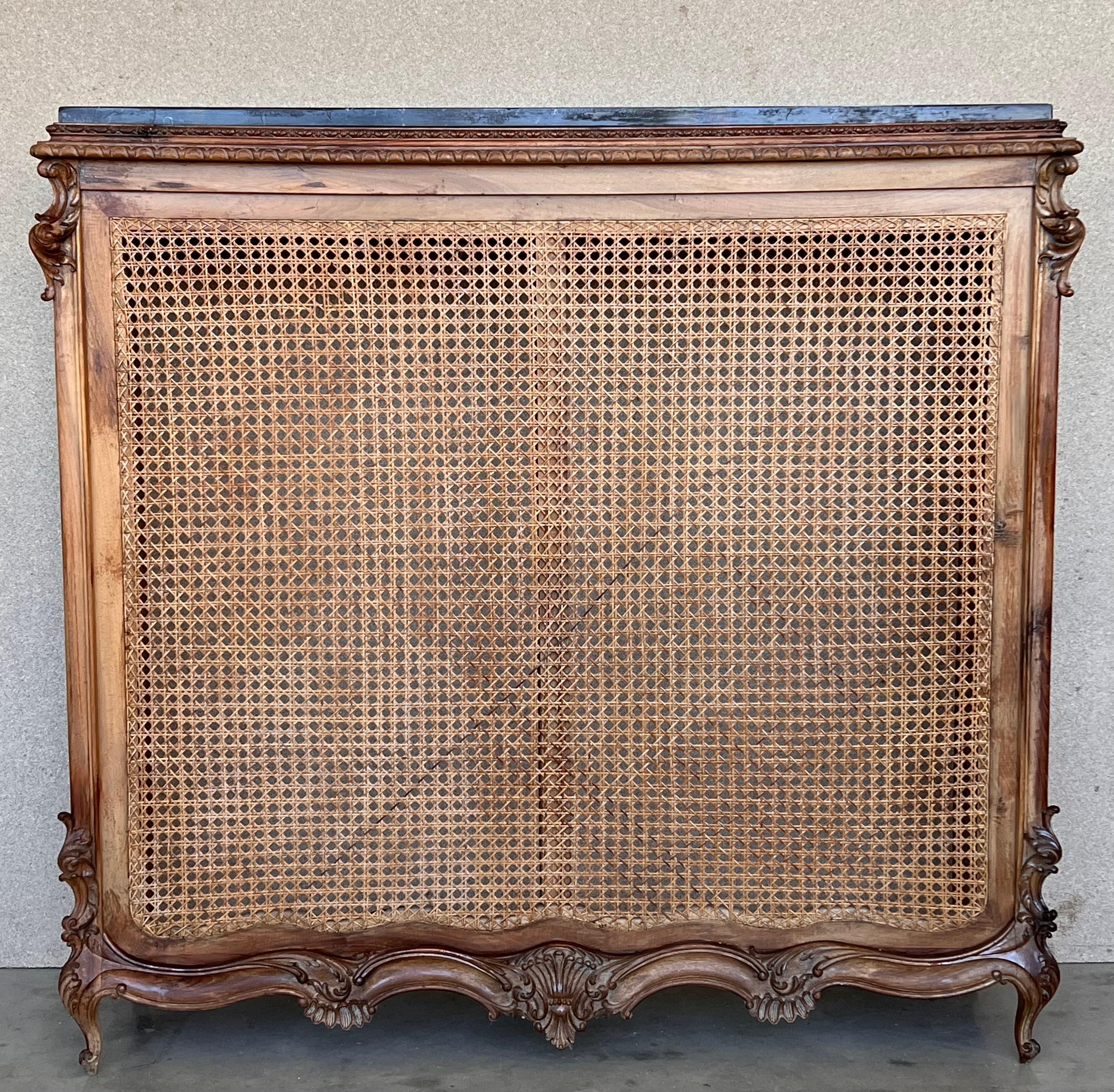 Louis XV Style carved walnut and cane console or radiator cover, Spain, circa 1920.
The cane is in perfect condition and has a black top marble.
The piece is very resistant.