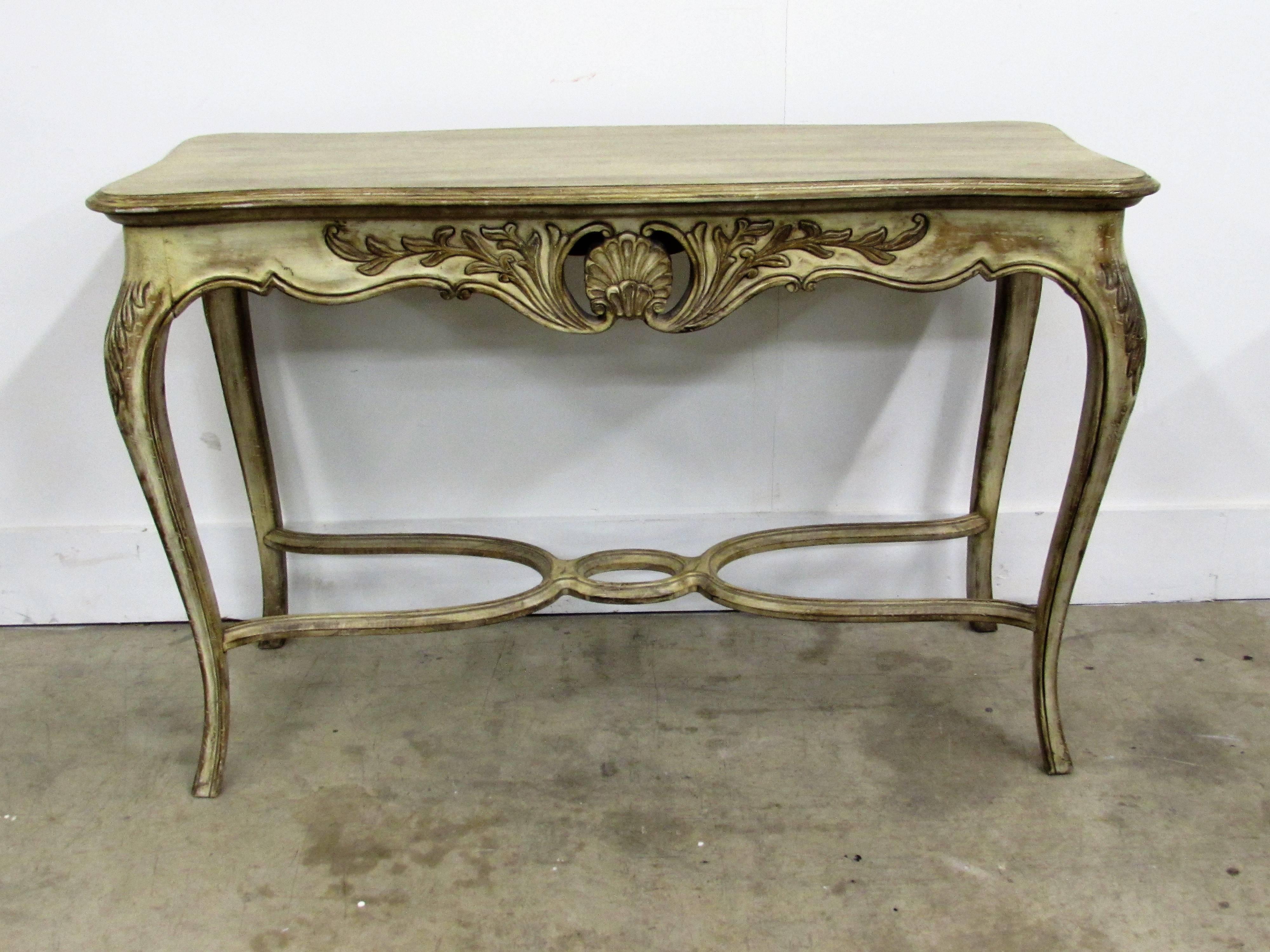 Louis XV style carved wood console table with shell motif and acanthus carved cabriolet legs antiqued, glazed and distressed, ending with a modern stretcher.