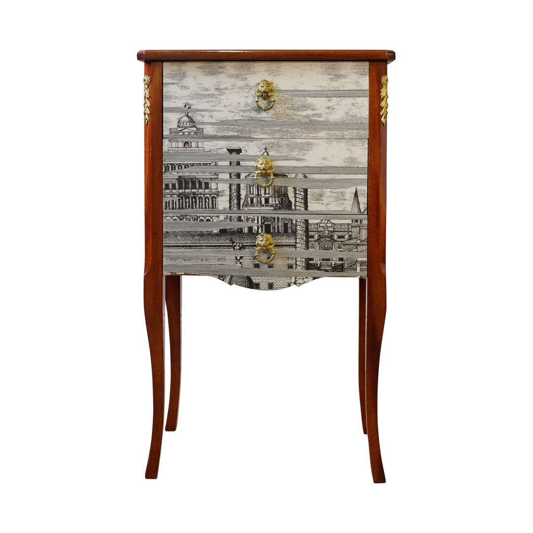 A Louis XV style chest with original brass details, wooden top and handles in birch wood with a Fornasetti pattern of ancient Rome. 
Measures: Width: 43cm / 16.9