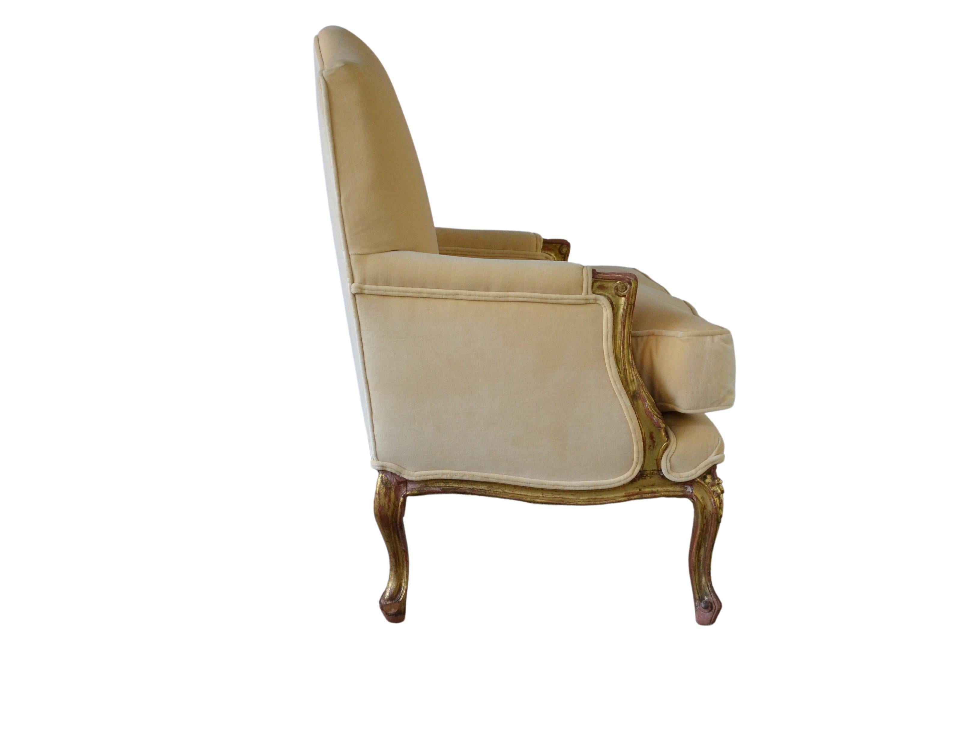 Louis XV style club chairs. Gilded frame covered in velvet fabric. The cushion down fills.