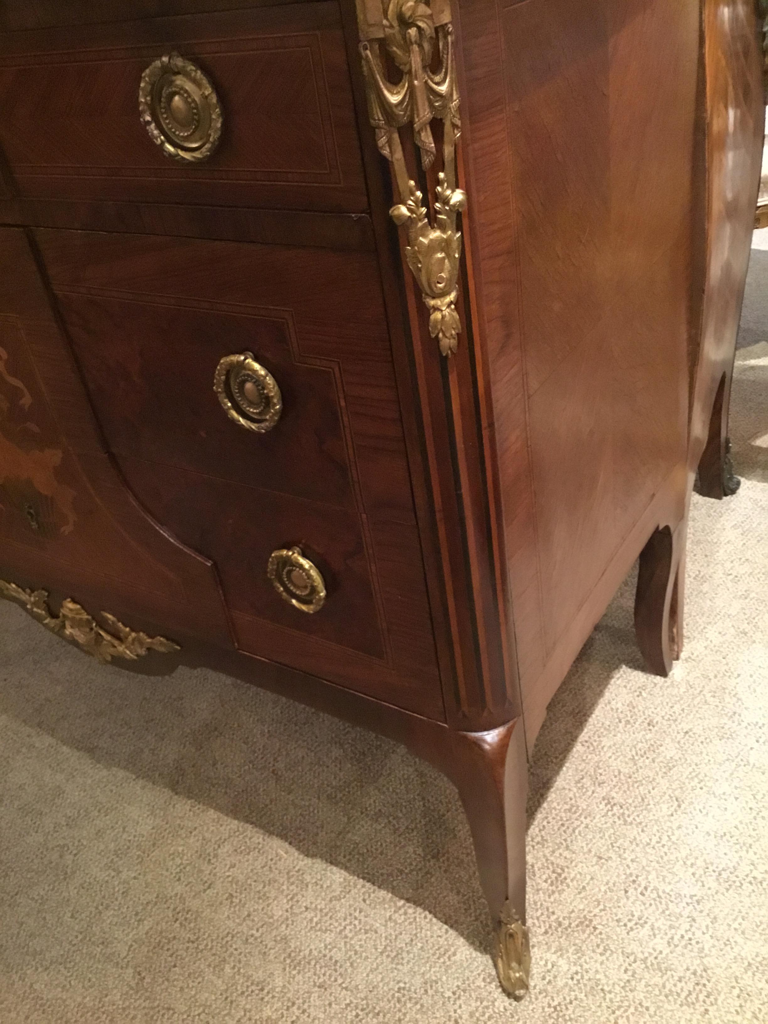 Excellent quality commode with three drawers having beautiful bronze pulls
And a lovely bronze doré plaque inset into the top drawer depicting
Angels and a country motif. The center of the cabinet has excellent marquetry 
Inlays of satinwood