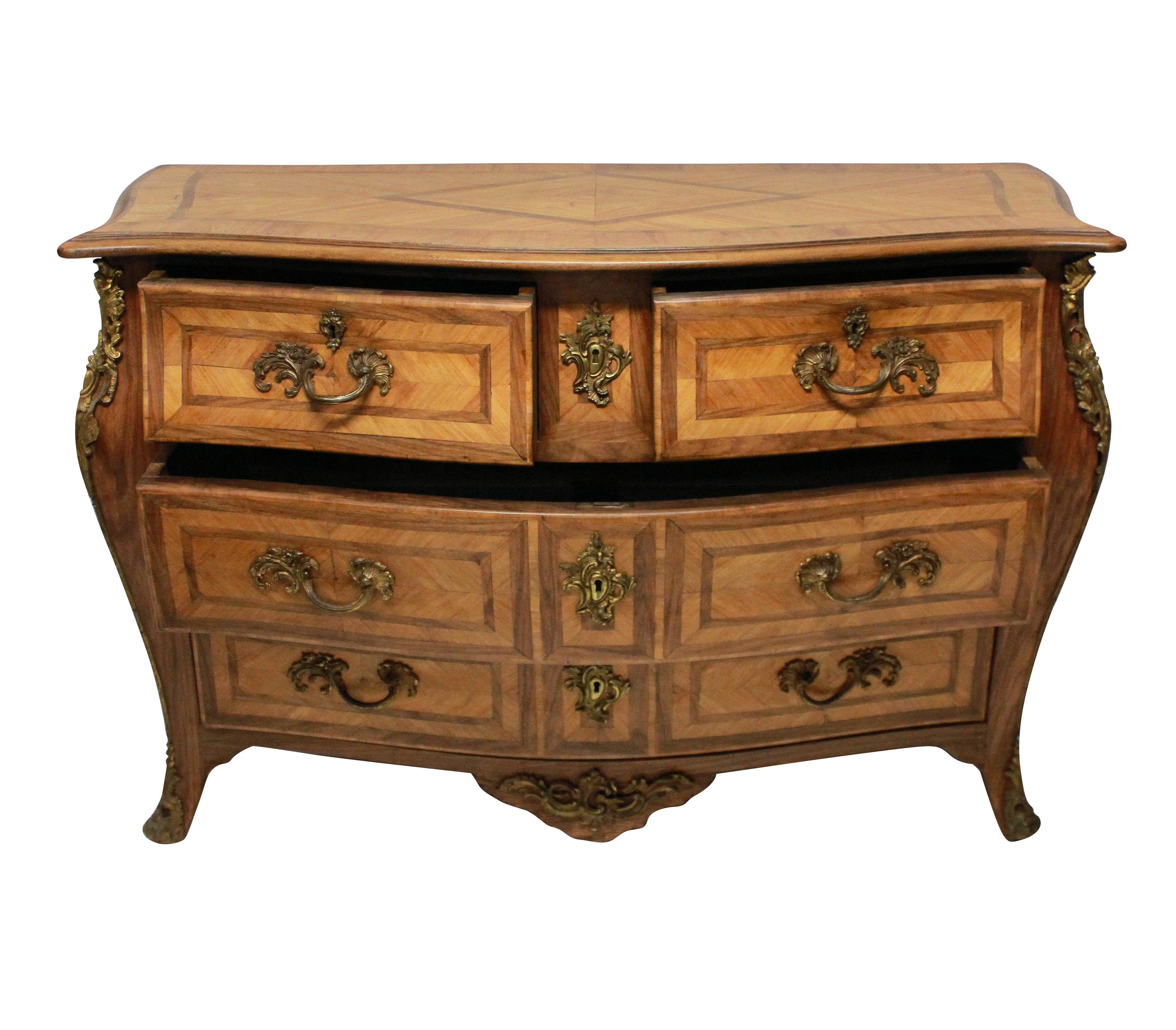 A fine French Louis XV style bombe commode in pale, bleached rosewood and kingwood. The handles and fittings in gilt bronze. The marquetry in geometric designs.

  