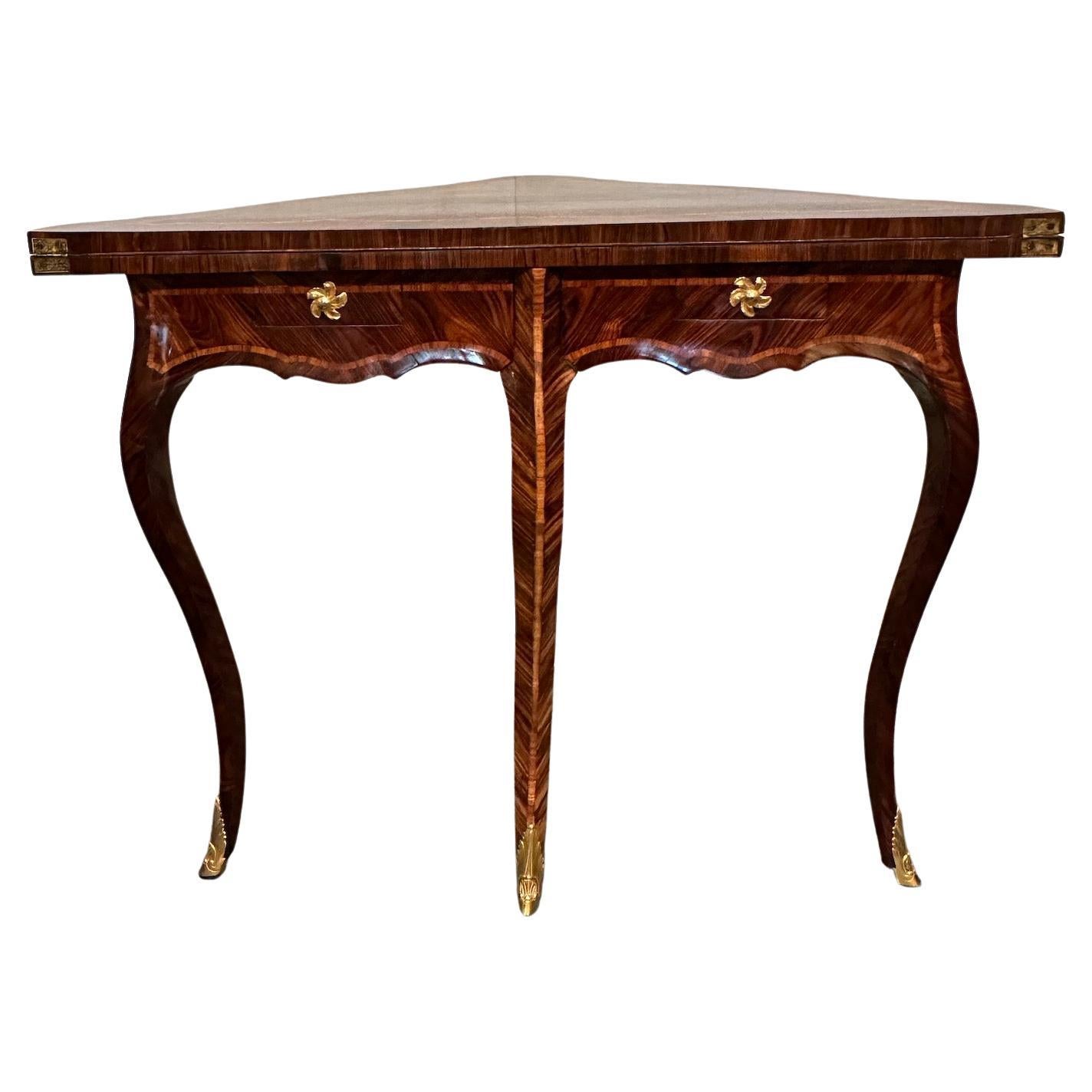 An elegant and beautiful Louis XV style burled mahogany and kingwood veneer corner games table.  Gilded bronze knobs and sabots.  2 drawers.  Top opens to  30