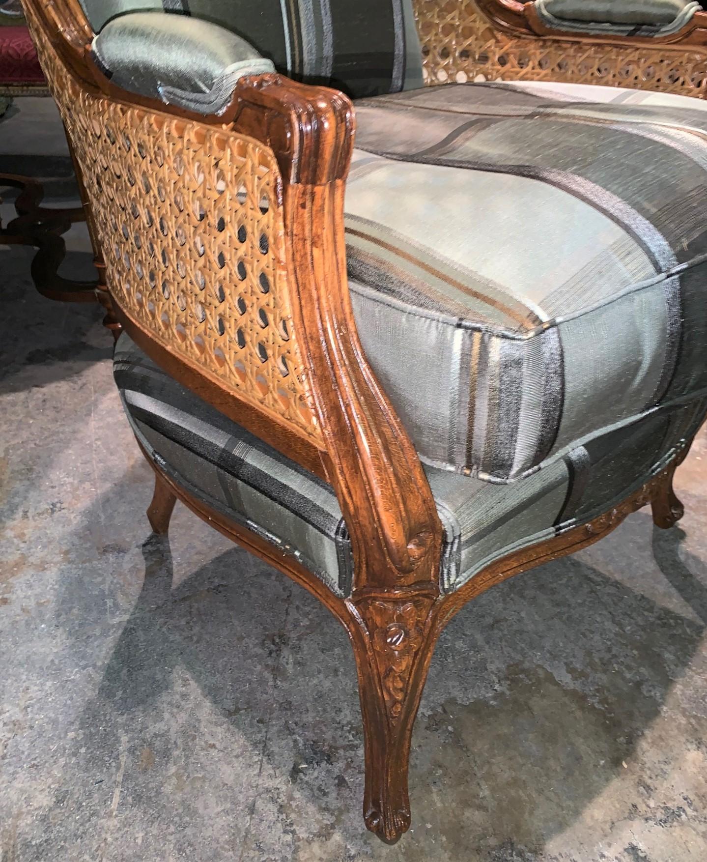 Outstanding pair of Louis XV style custom crafted walnut dome chairs or balloon chairs with superior double caning and hand carved crests. Each resting on cabriole legs. Perfectly proportioned. Ready for your creative design.