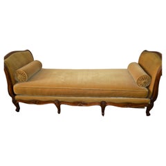 Louis XV style daybed, walnut frame and gold velvet upholstery.