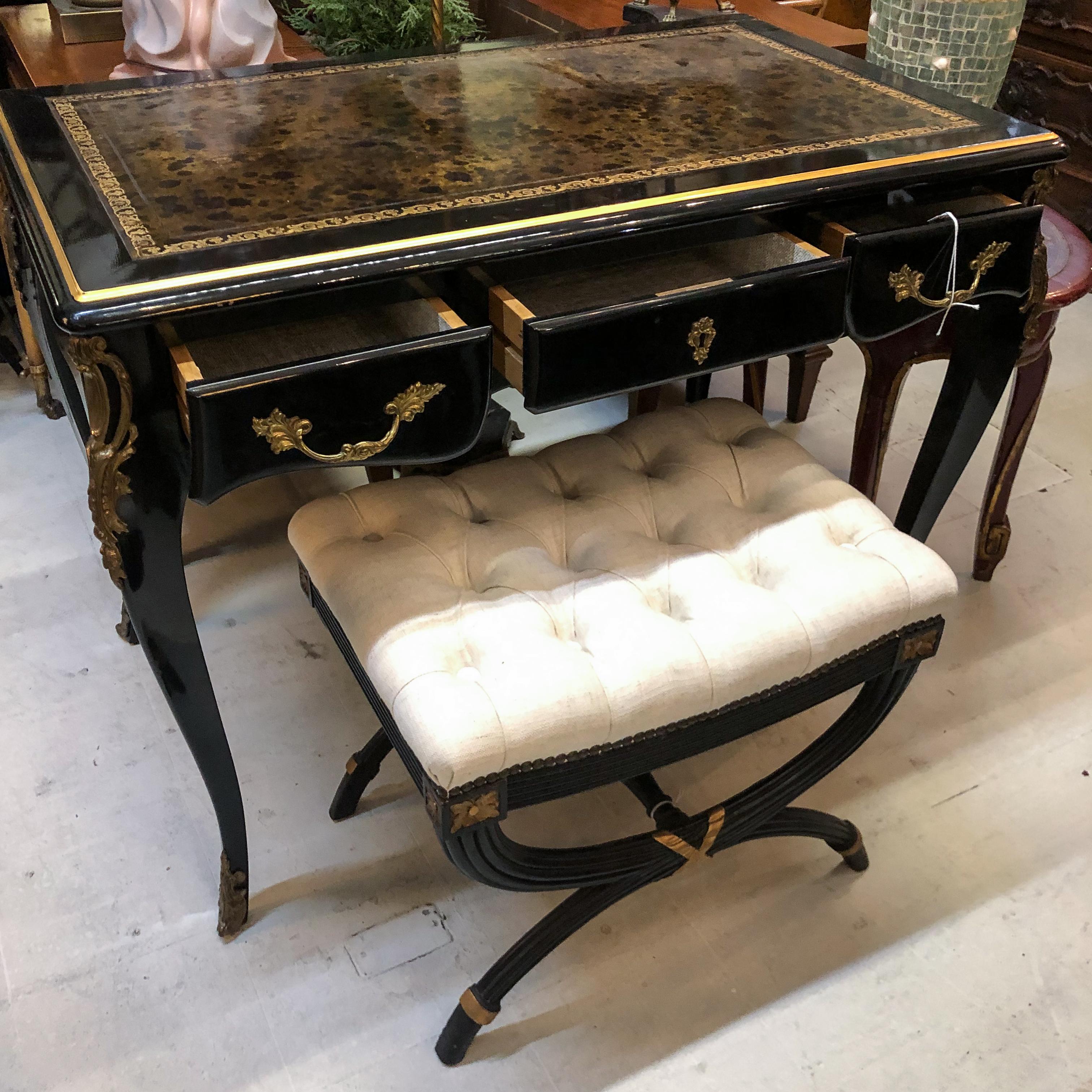 Black lacquer Louis XV style desk / secretary with brass details and leather top

Neoclassical stool in black lacquer with gilt details and beige linen tufted seat. Dimensions: 22