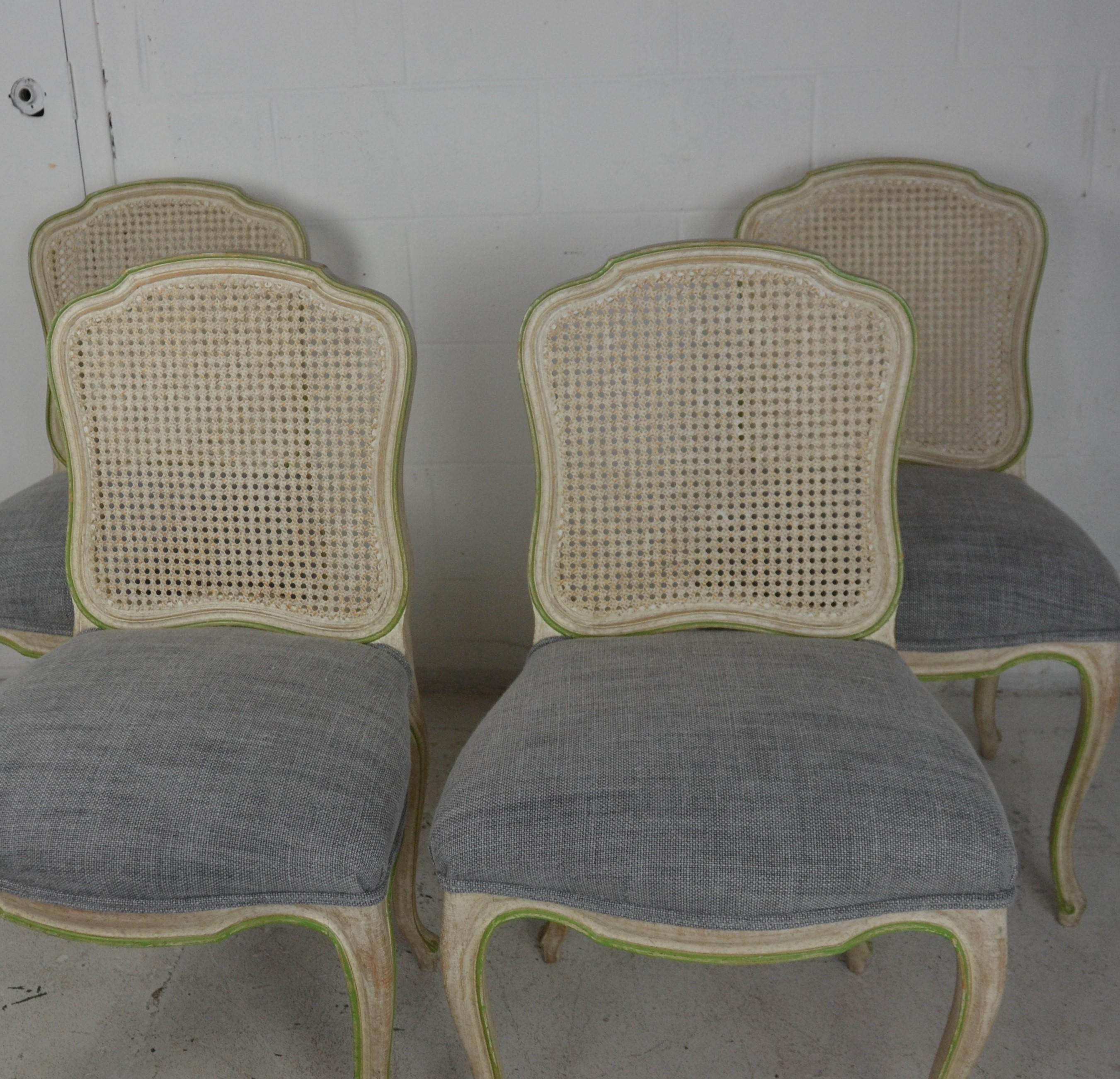 A set of 4 Louis XV Style Dining Chairs . Original paint finish. Cane seats . New upholstery