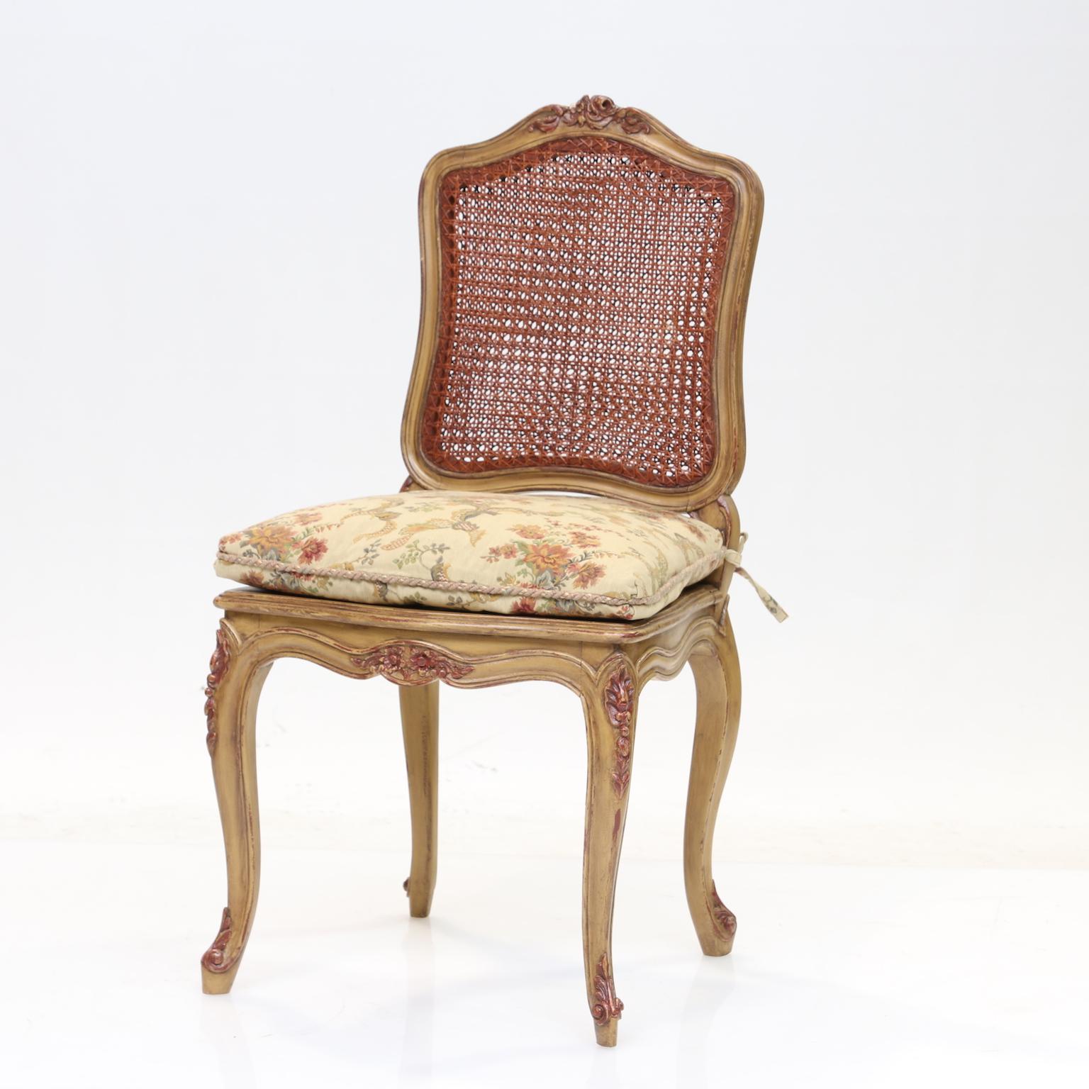 Louis XV style dining chairs set of 10
Set of 10 painted Louis XV style dining chairs with cane backs and seats and tie on cushion seats. The cane finished in a slight red tone which blends well with the paint which is highlighted with soft reds on