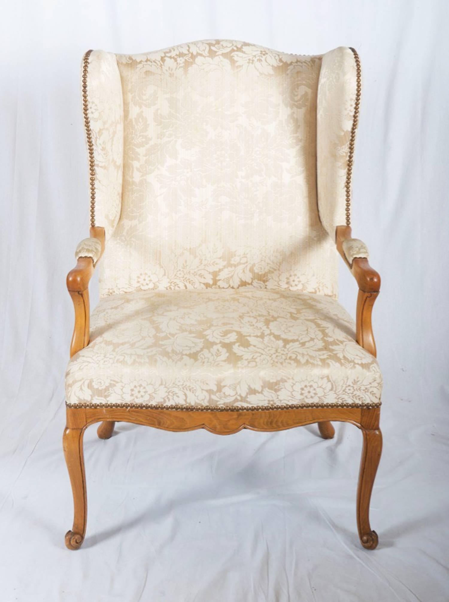 Carved walnut frame cushioned seat and upholstered in gold or beige damask.