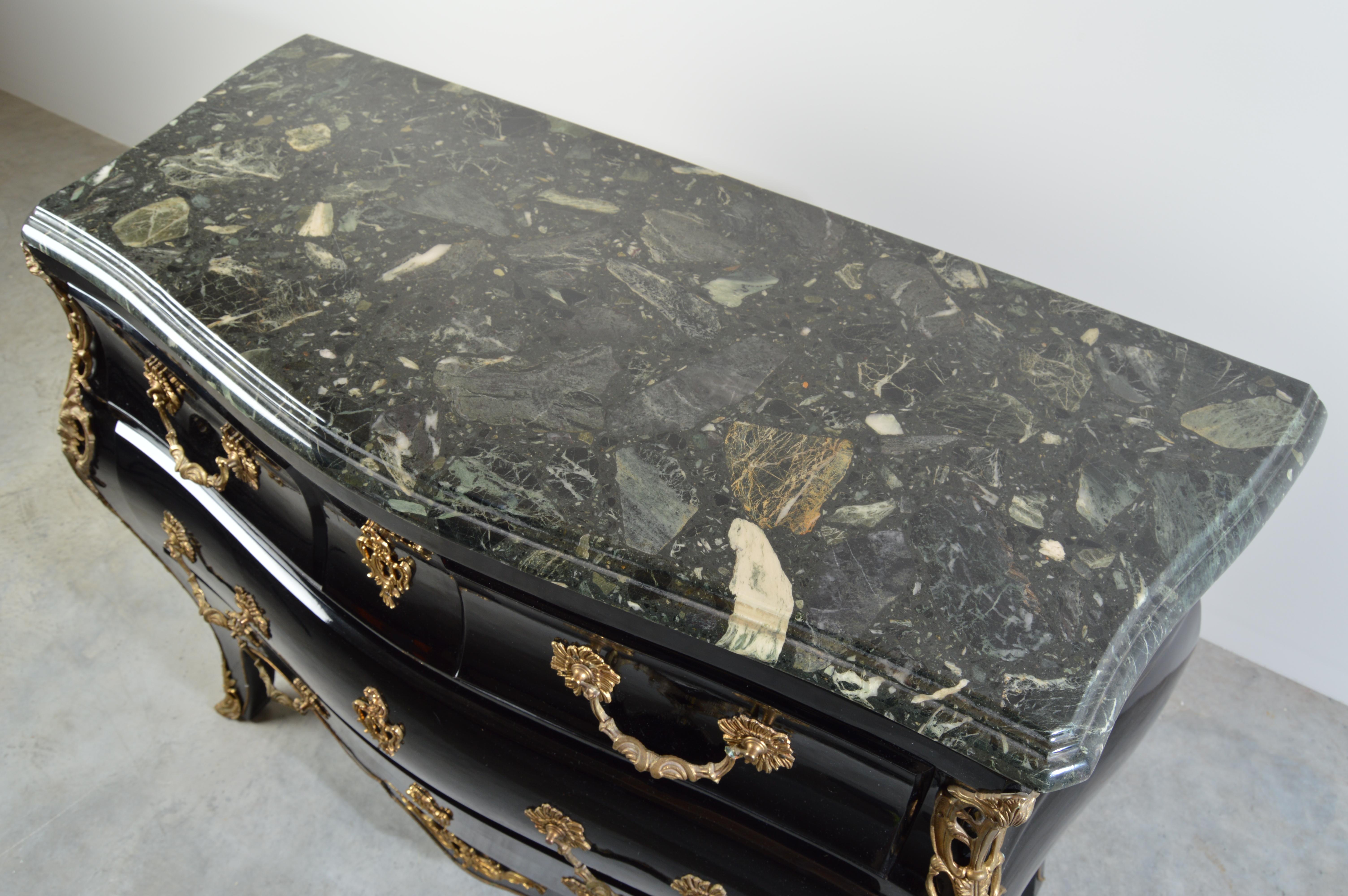 Late 19th century Louis XV style ebonized bombe chest commode mable and bronze details accenting this gorgeous piece. The commode is ornamented with chiselled and gilt bronze throughout. The shaped Breche d'Alep marble top has a molded edge above