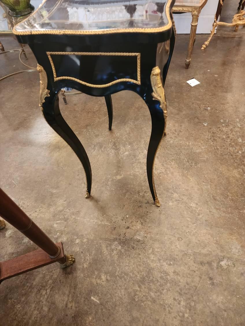 Louis XV Style Ebonized Poudreuse
dressing table with mirror, sliding tray, and brass mountings, hinged top and false drawer to front.