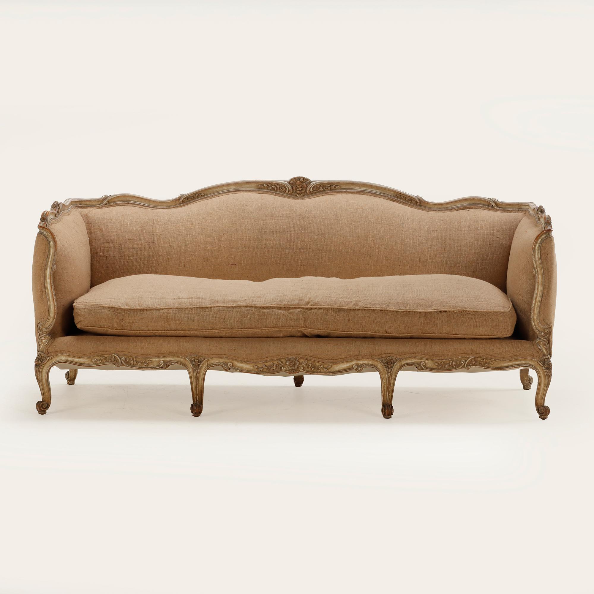 Louis XV style even arm sofa C 1910 having a nicely carved, painted frame and new fabric.