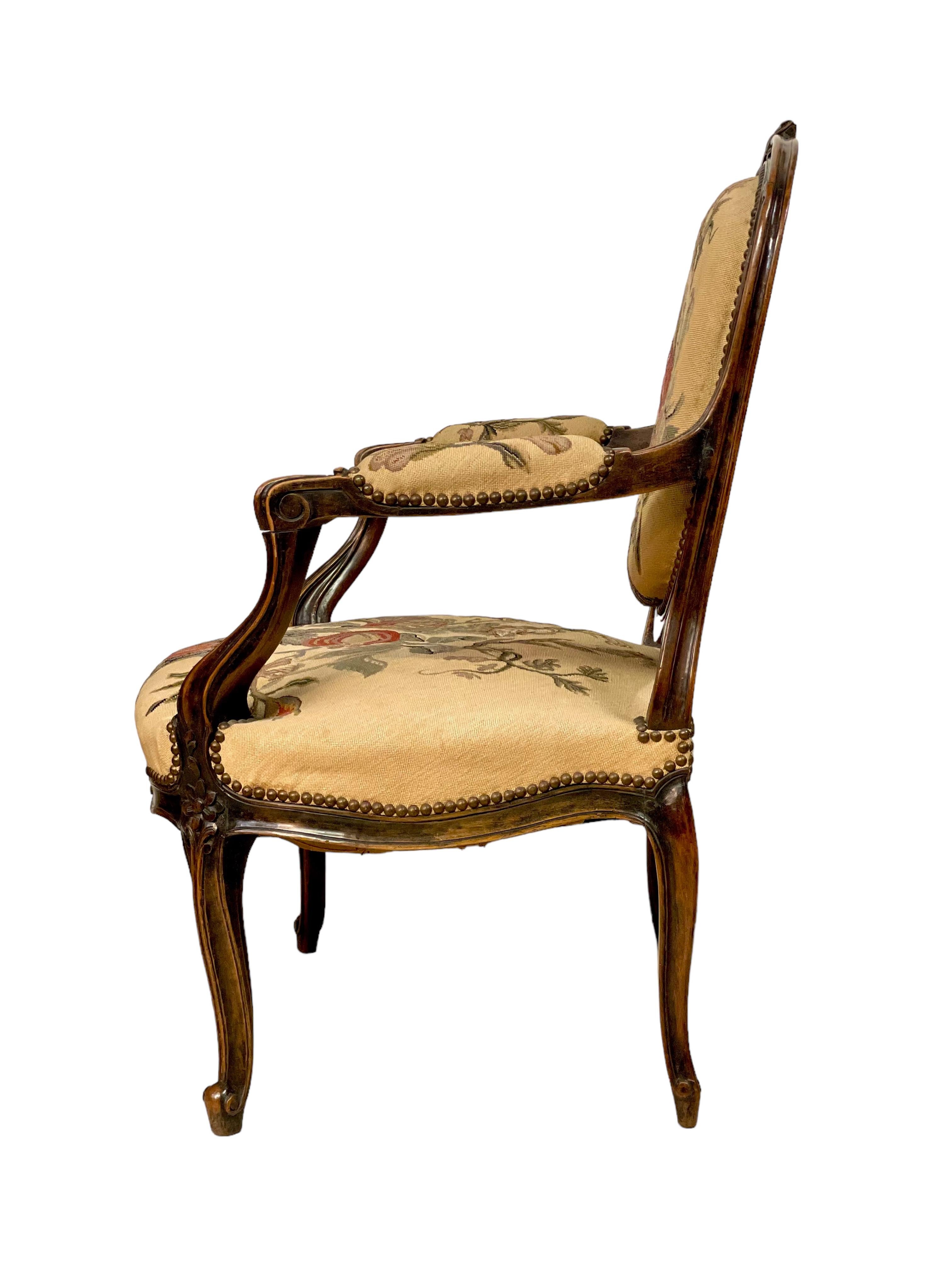 A sumptuous and beautifully upholstered 'Fauteuil à la Reine' armchair, in the Louis XV style and dating from the Napoleon III period. Crafted from moulded, and formerly blackened, walnut, this wonderful antique chair has a wide and comfortable seat