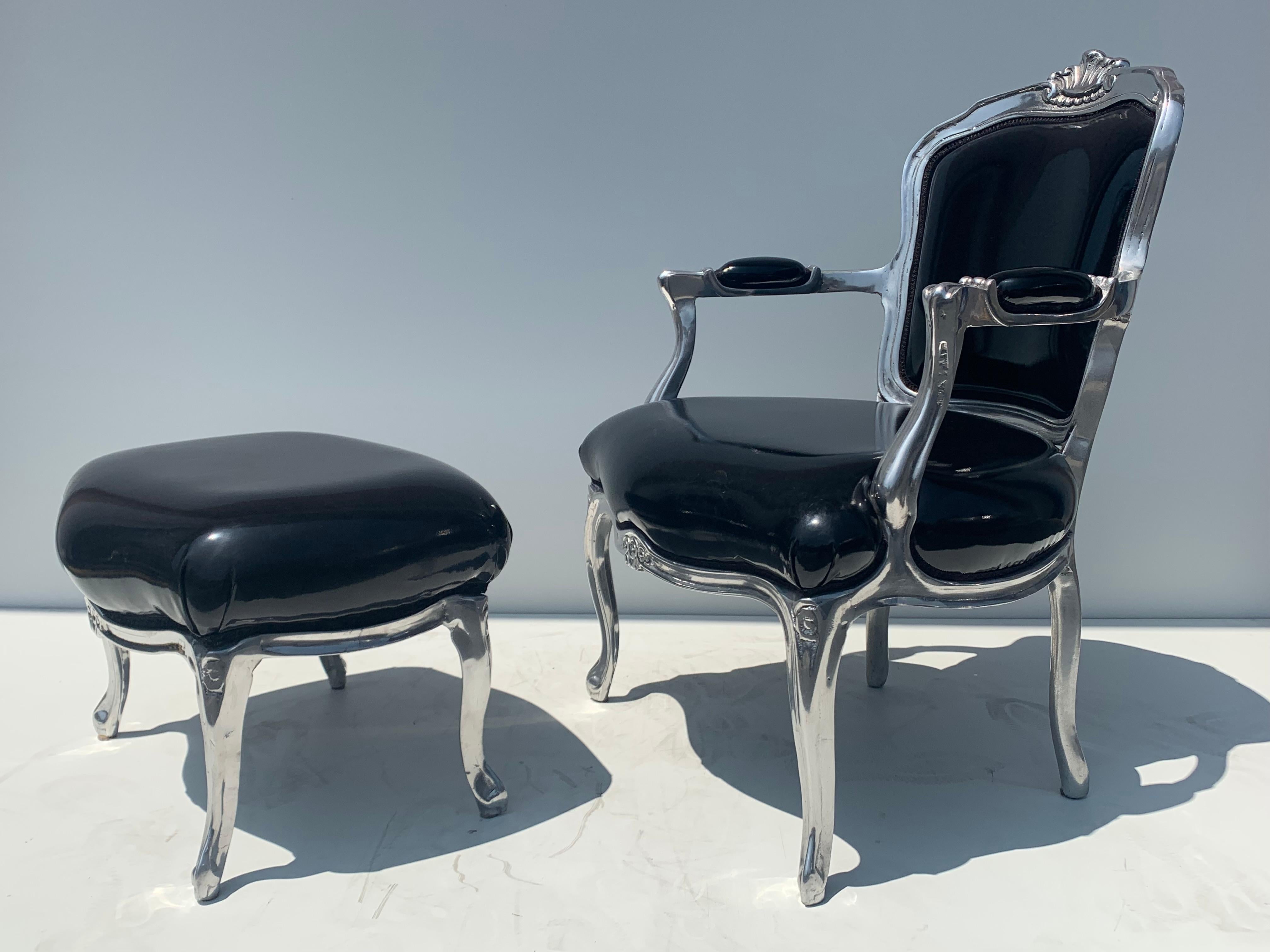 Fauteuil chair and footrest in solid aluminum upholstered in black soft vinyl in he style of Louis XV. Footrest is 23
