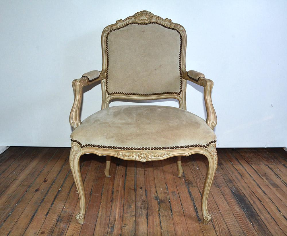 Distinctive vintage Louis XV style hand carved armchair having open and down swept arms and elegant cabriole legs. Upholstery shows wear and some staining.
Measures: Seat height 27