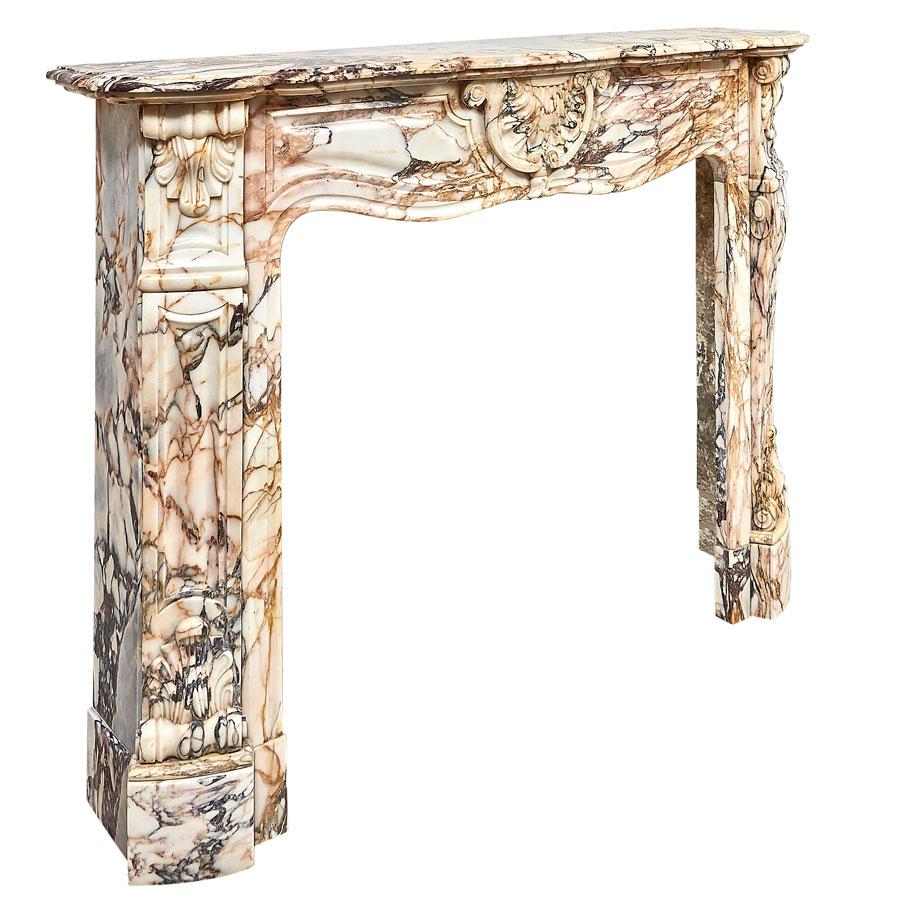 A French Calacatta Rosato-marble fireplace in the Louis XV-Rococo style. The shaped moulded shelf rest above a scrolled frieze, centred by a beautiful carved, foliate cartouche.  Angled endblocks above the tappering, panelled ànd carved jambs, who