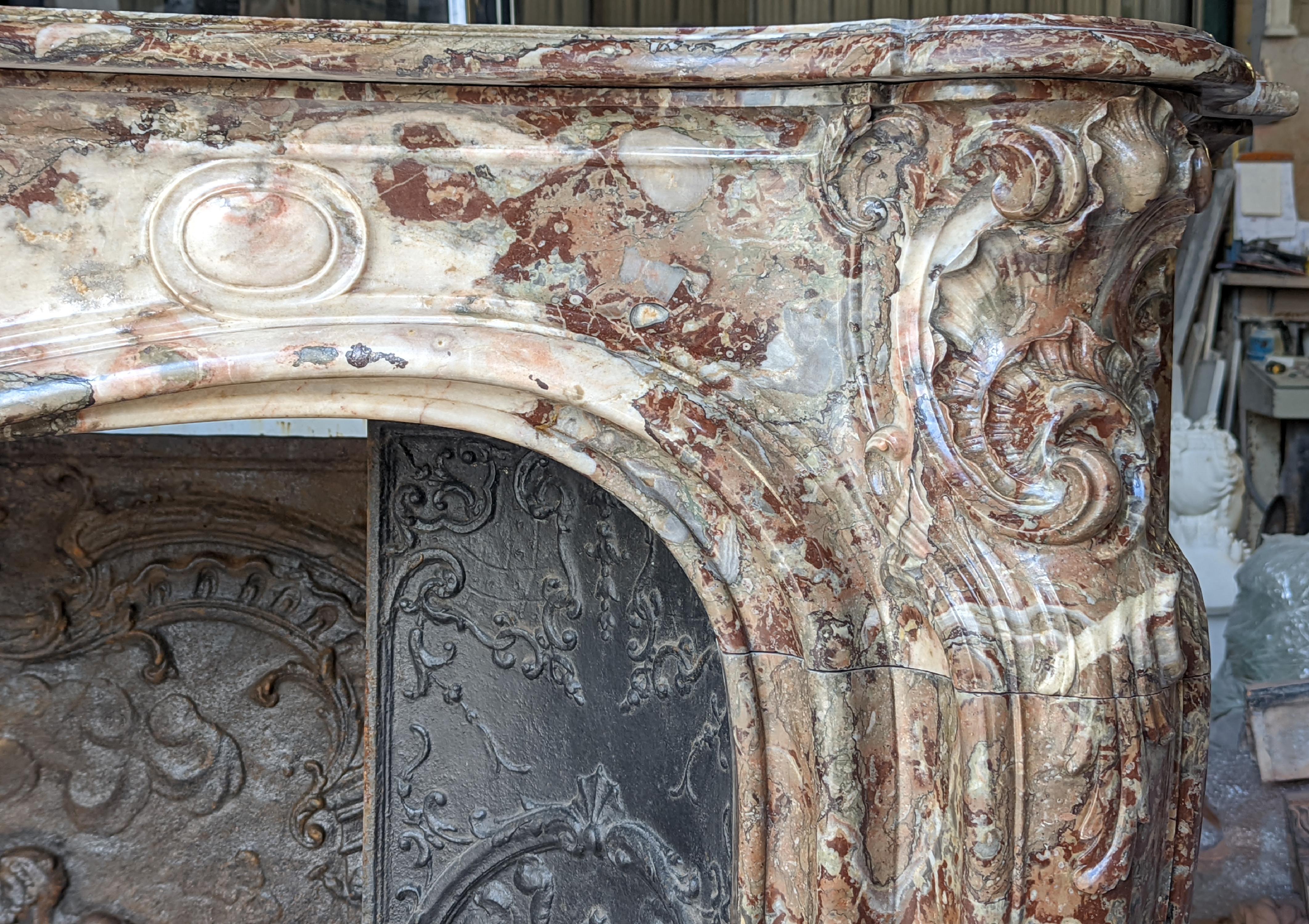 Louis XV style fireplace in Rouge Royal marble with an asymmetrical shell 4
