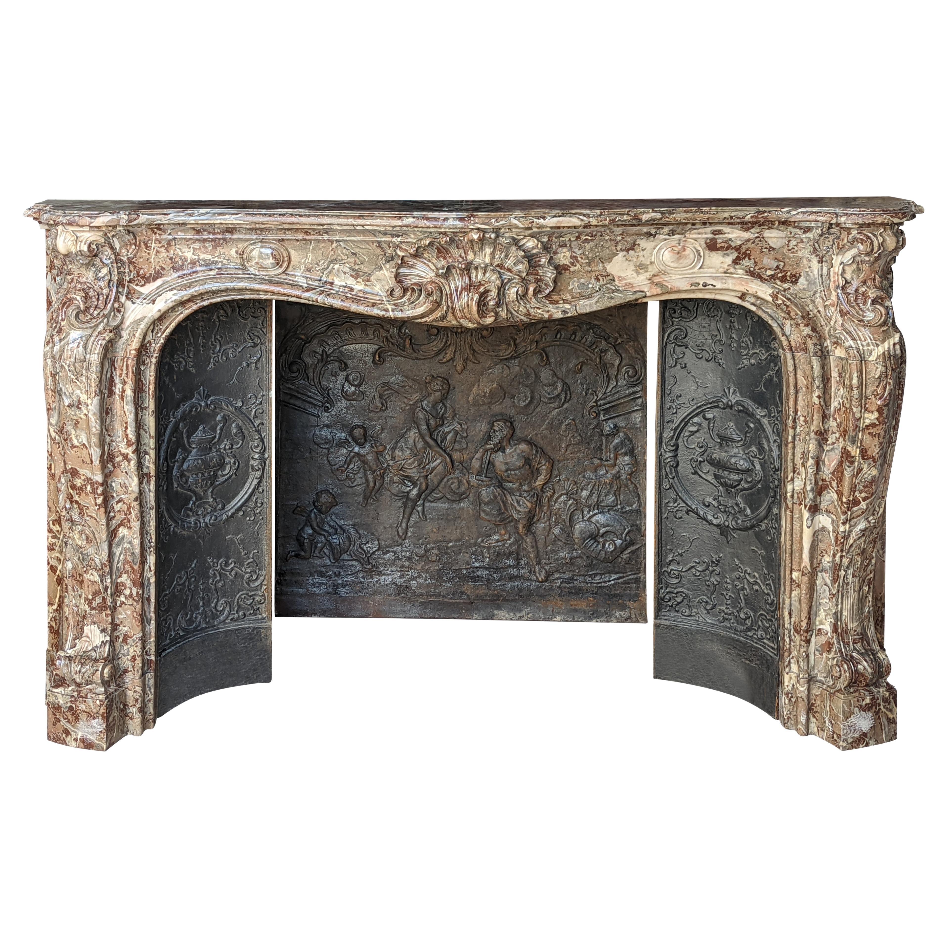 Louis XV style fireplace in Rouge Royal marble with an asymmetrical shell