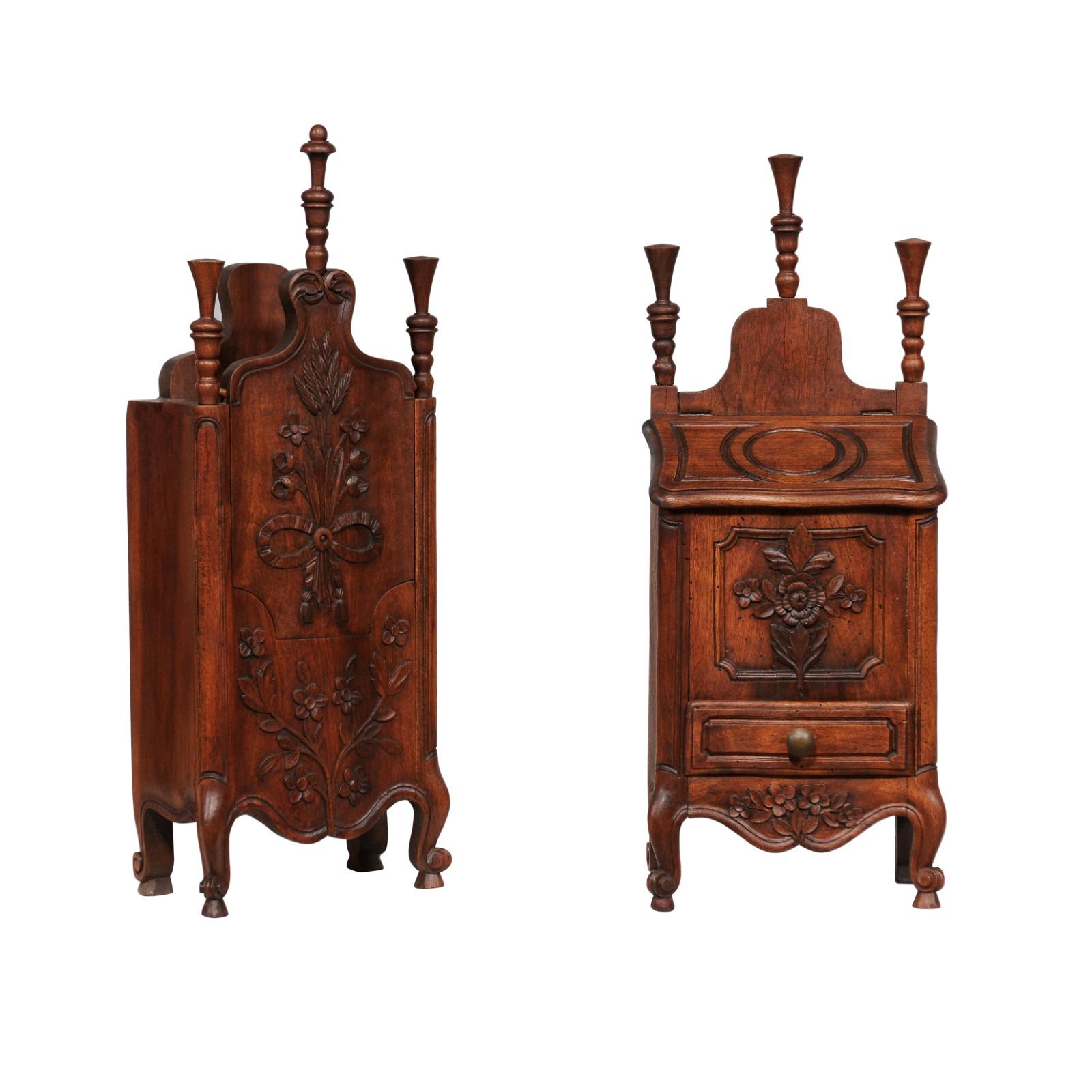 Two French Louis XV style walnut farinerio flour boxes from the 19th century with carved floral motifs, cabriole legs and tall finials. They are priced and sold each. This charming pair of French Louis XV style walnut 'farinerio' flour boxes, dating