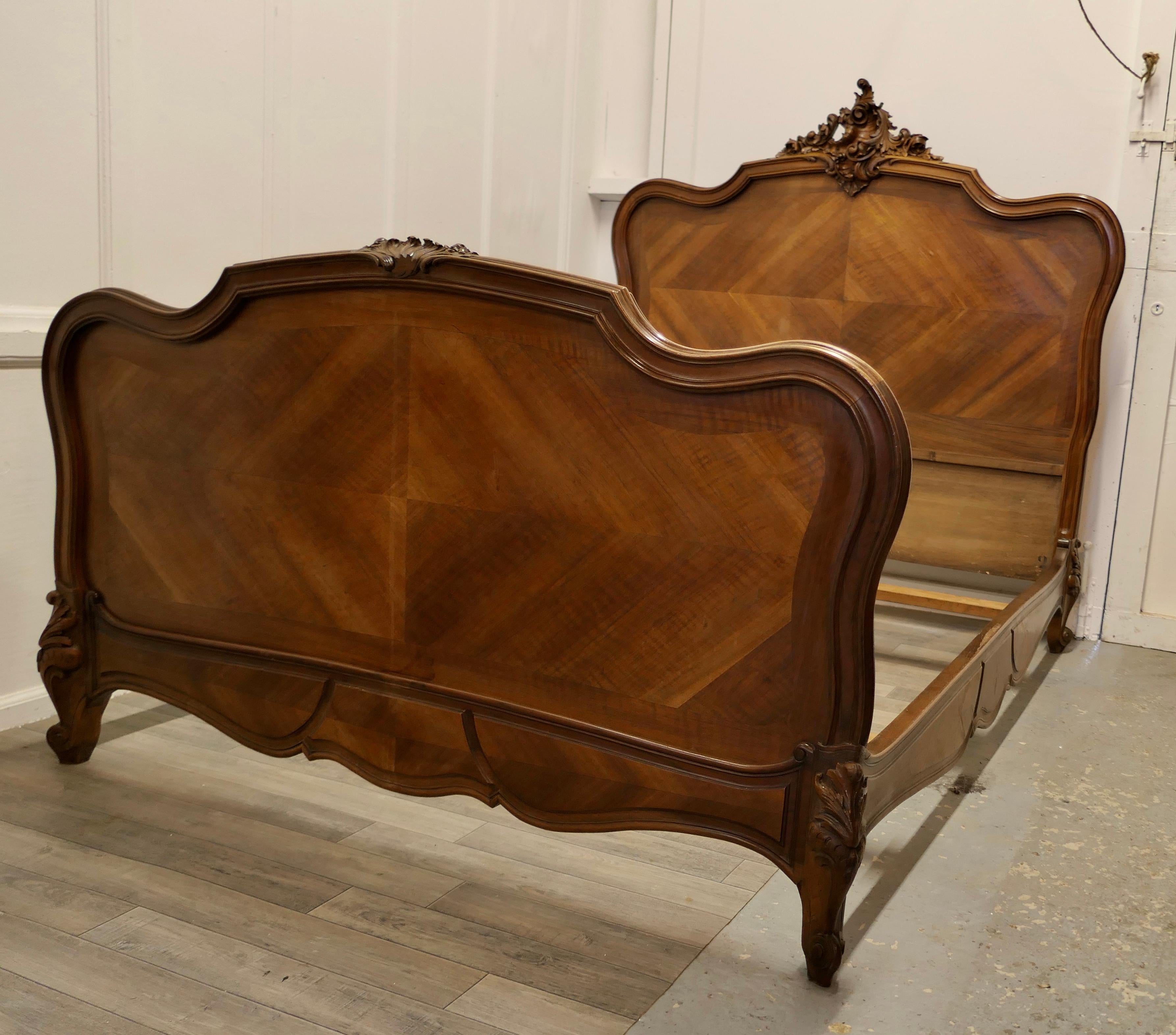 Louis XV Style French golden walnut bed

The bed is made in quarter veneered walnut and has a superbly carved crest on the headboard, the carved decoration is repeated on the feet and the footboard 
The bed is in good condition, the internal
