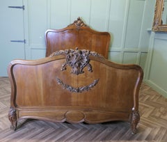 Louis XV Style French Golden Walnut Bed  The bed has a superbly carved crest