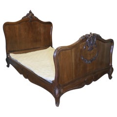 Louis XV Style French Golden Walnut Bed  The bed has a superbly carved crest
