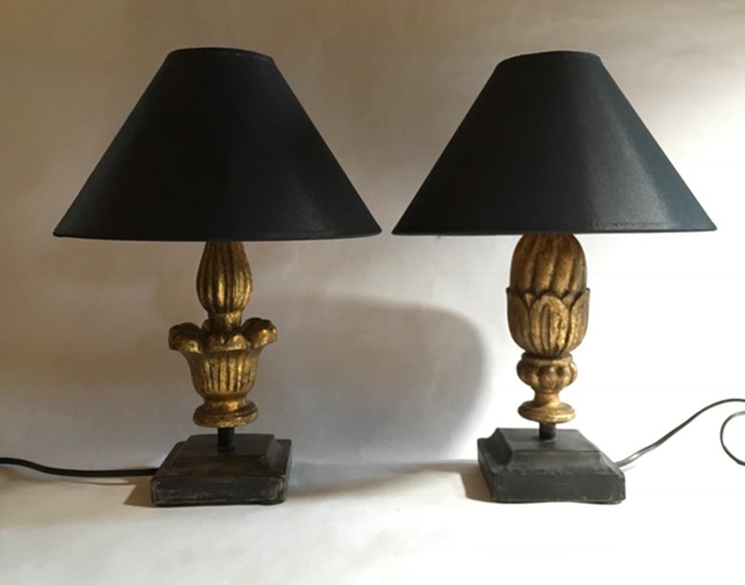 Louis XV style French pair of table lamps in golden patinated wood with wrought iron bases

This an agreeable pair but with two different shape: color and dimensions are the same
but it's very modern to use different pieces put together. Perfect