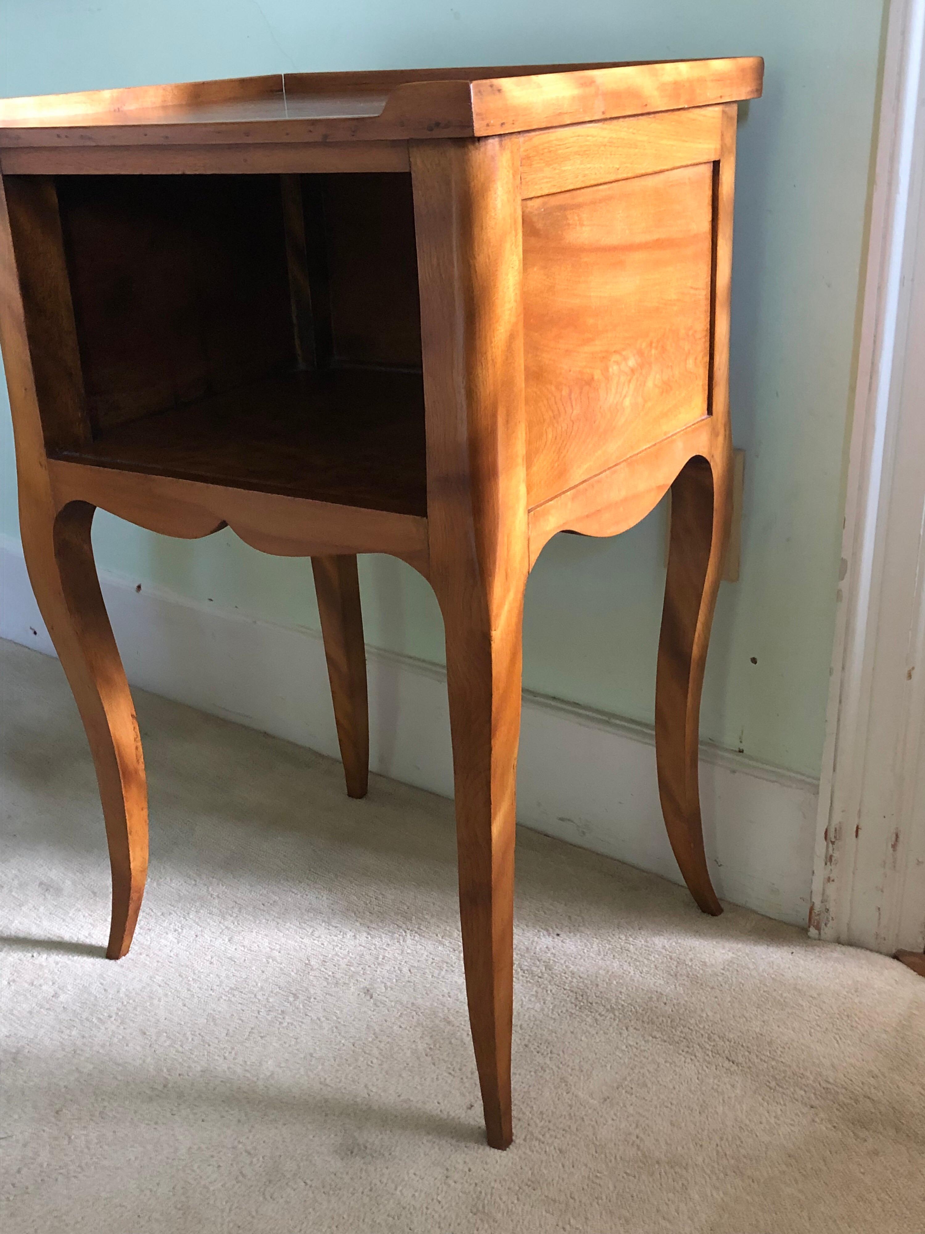 Late 19th -early 20th century Louis XV style table de chevet or nightstand. Graceful cabriolet legs and ample shelf for books and necessities. Light mahogany in color.