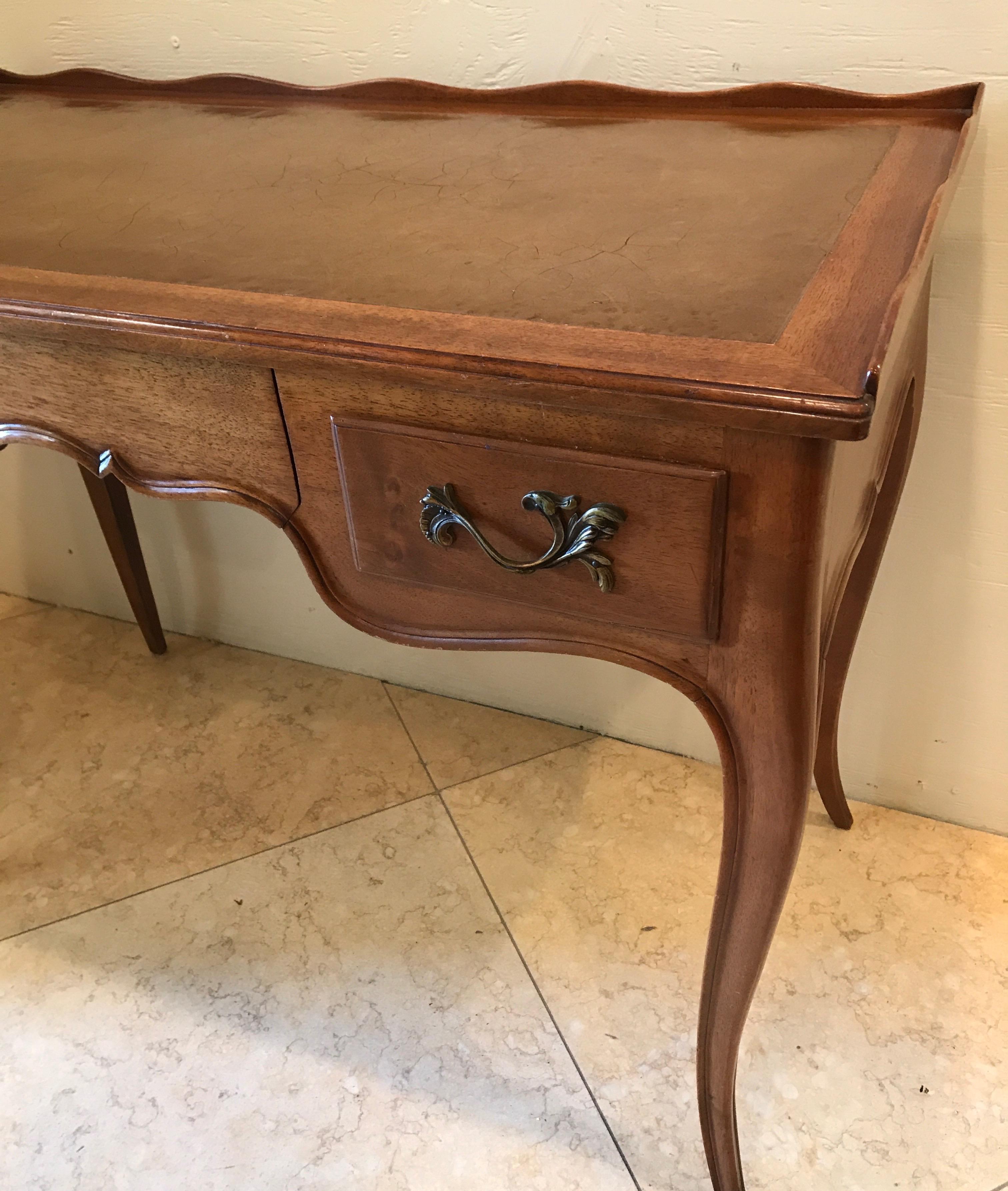 Ladies French writing desk with leather top and three drawers.