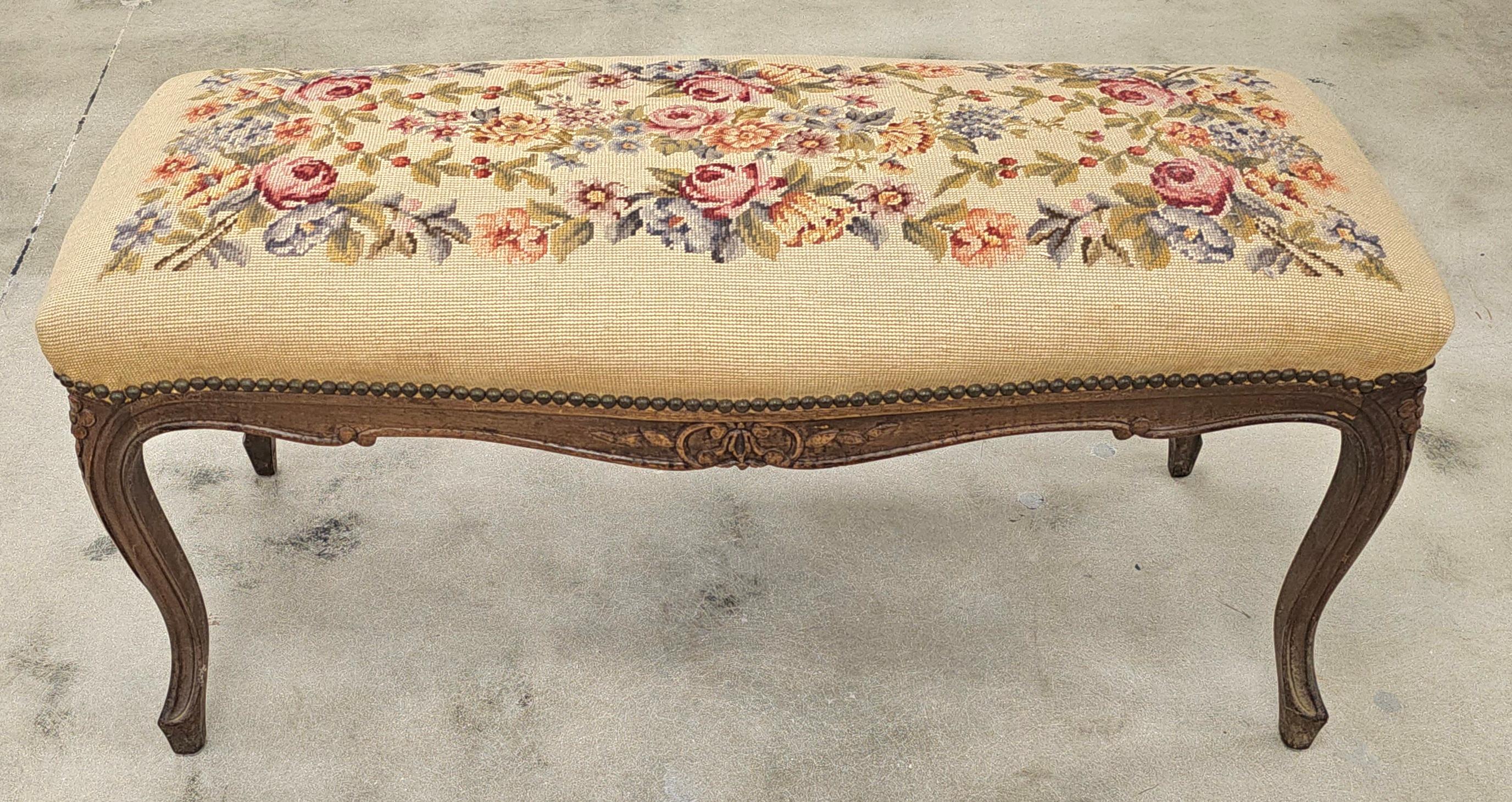 A Louis XV Style Fruitwood and Needlepoint Upholstered Bench. 
Measures 38