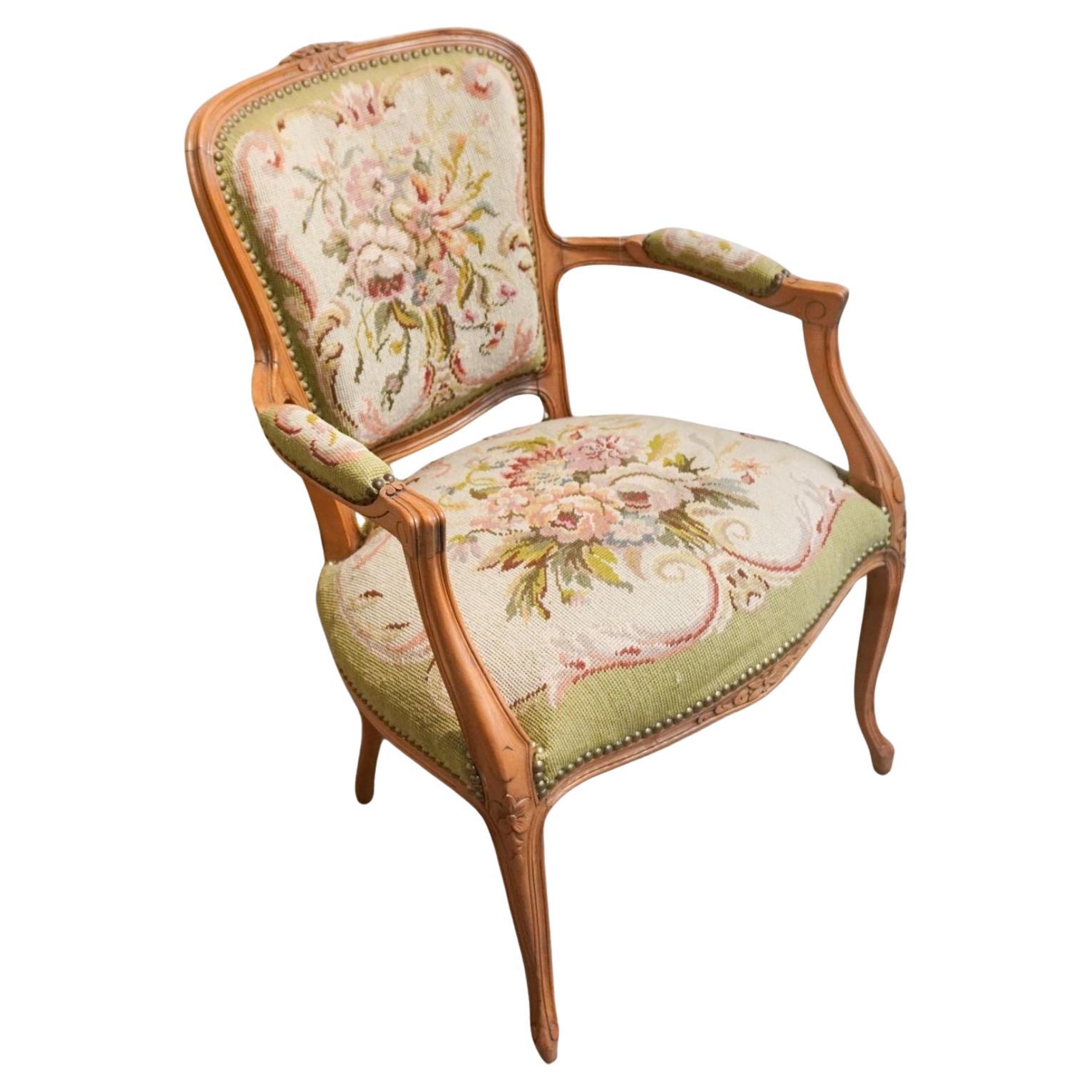 A Louis XV Style Fruitwood And Needlepoint Upholstered Fauteuil.
Measures Meaures 23.5