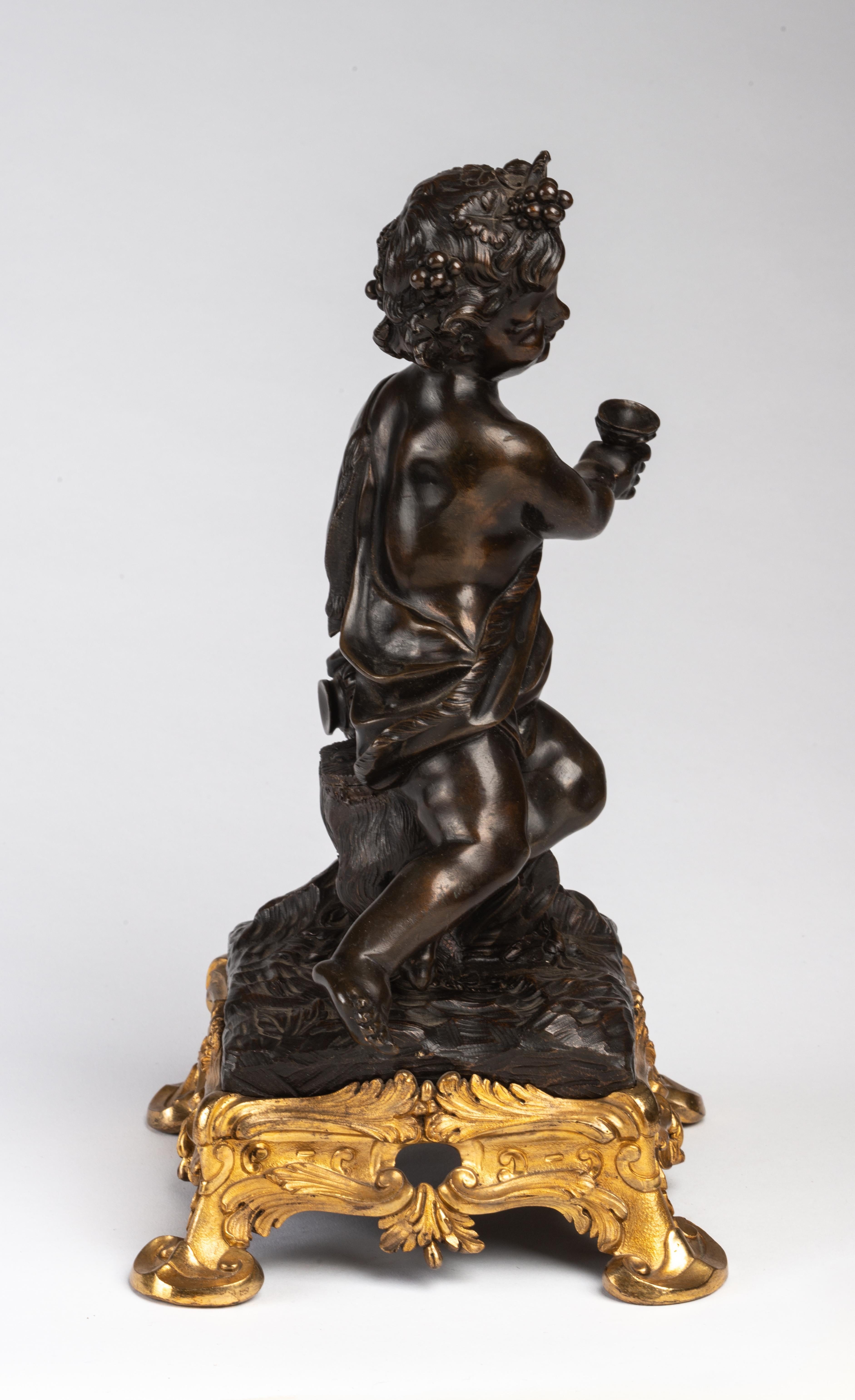 With a figure of a child dressed as a Bacchic figure with grape-leaf entwined hair and holding a cup while leaning on a bottle, raised on a scrolled rocaille base.
With an interesting provenance, Mrs. Douglas Dillon, wife of The Honorable C.