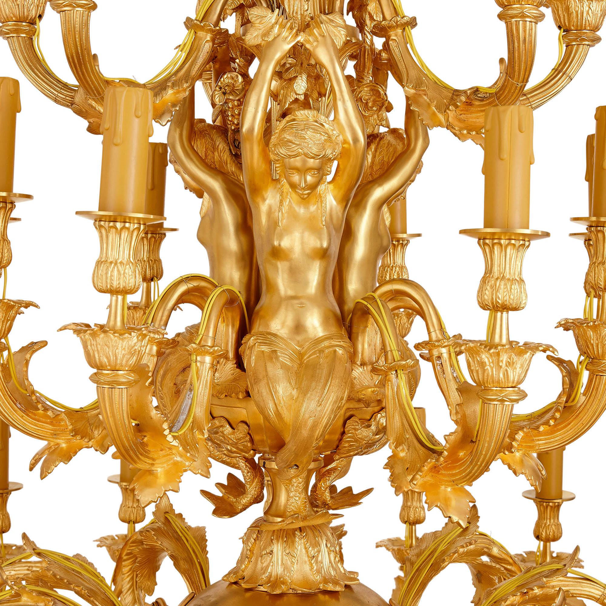 Louis XV style gilt bronze 33-light chandelier
French, 20th Century
Height 156cm, diameter 102cm

This beautiful chandelier is crafted from gilt bronze in the Rococo style of Louis XV. The chandelier features a shaped central column, which